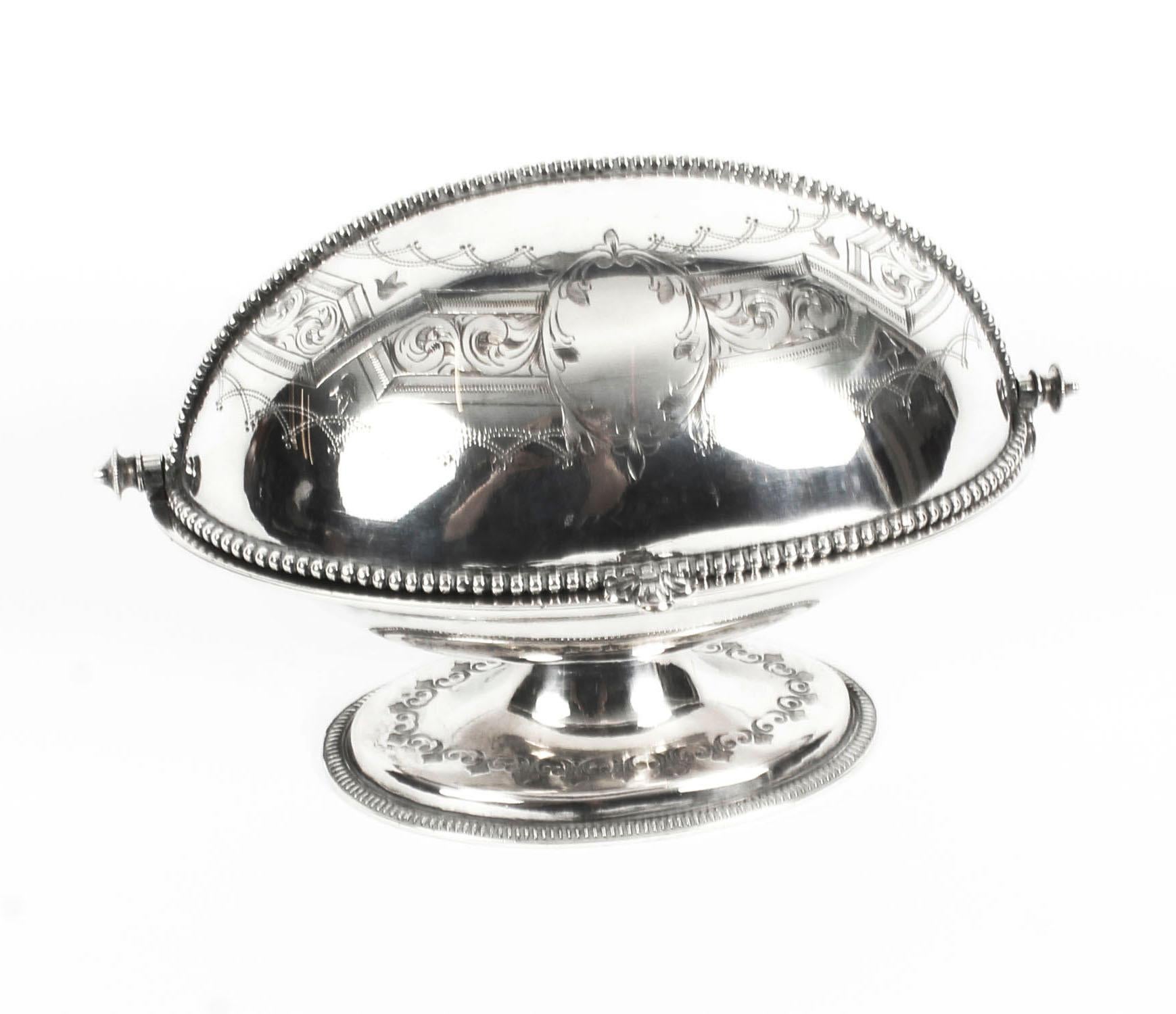 This is a gorgeous antique English Victorian silver plated roll over butter dish, circa 1870 in date.

With superb engraved and cast decoration the underside bearing the embossed label 
