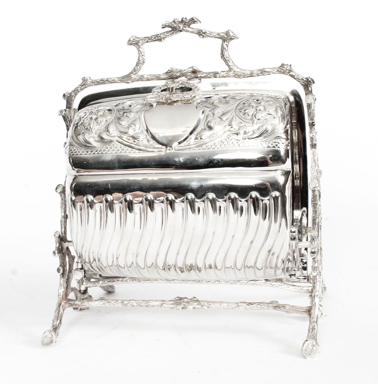 This is a superb antique Victorian silver plated folding biscuit box made by Mappin & Webb- Princes Plate reg No 71553, circa 1880 indate.

The opening mechanism is as intricate as the laurel wreath decoration, it features a foliate engraved body