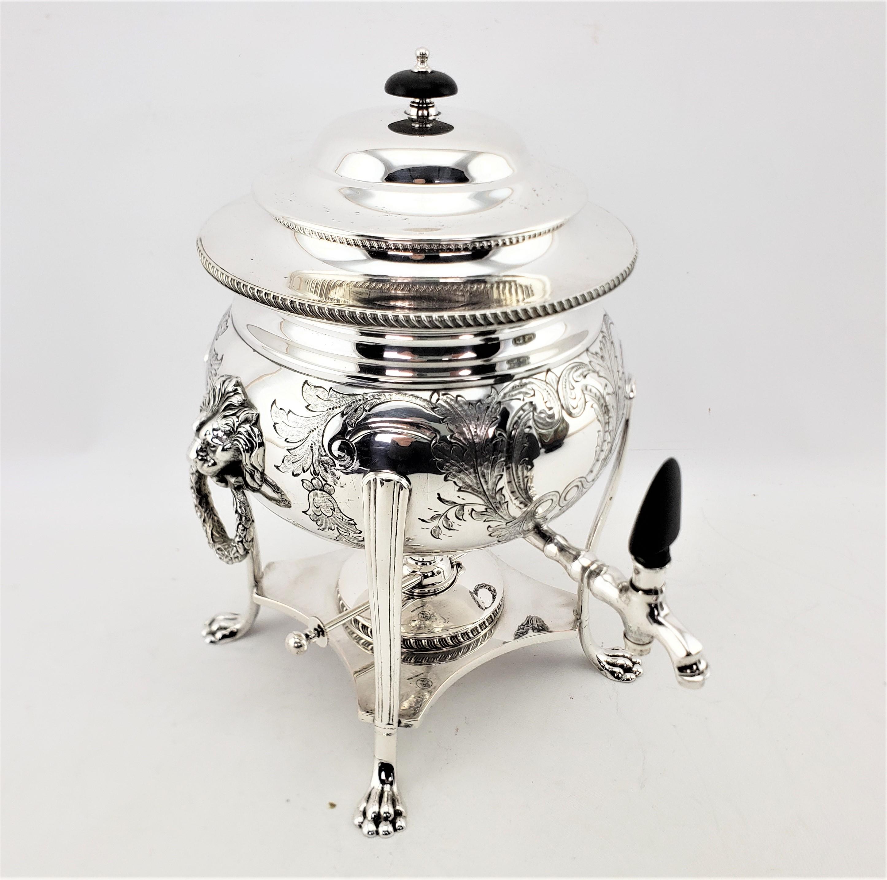 This small silver plated tea or hot water urn is hallmarked by an unknown maker, but clearly identified as originating from England and dating to approximately 1920 and done in a Victorian style. The urn has a round top with a wooden handle and