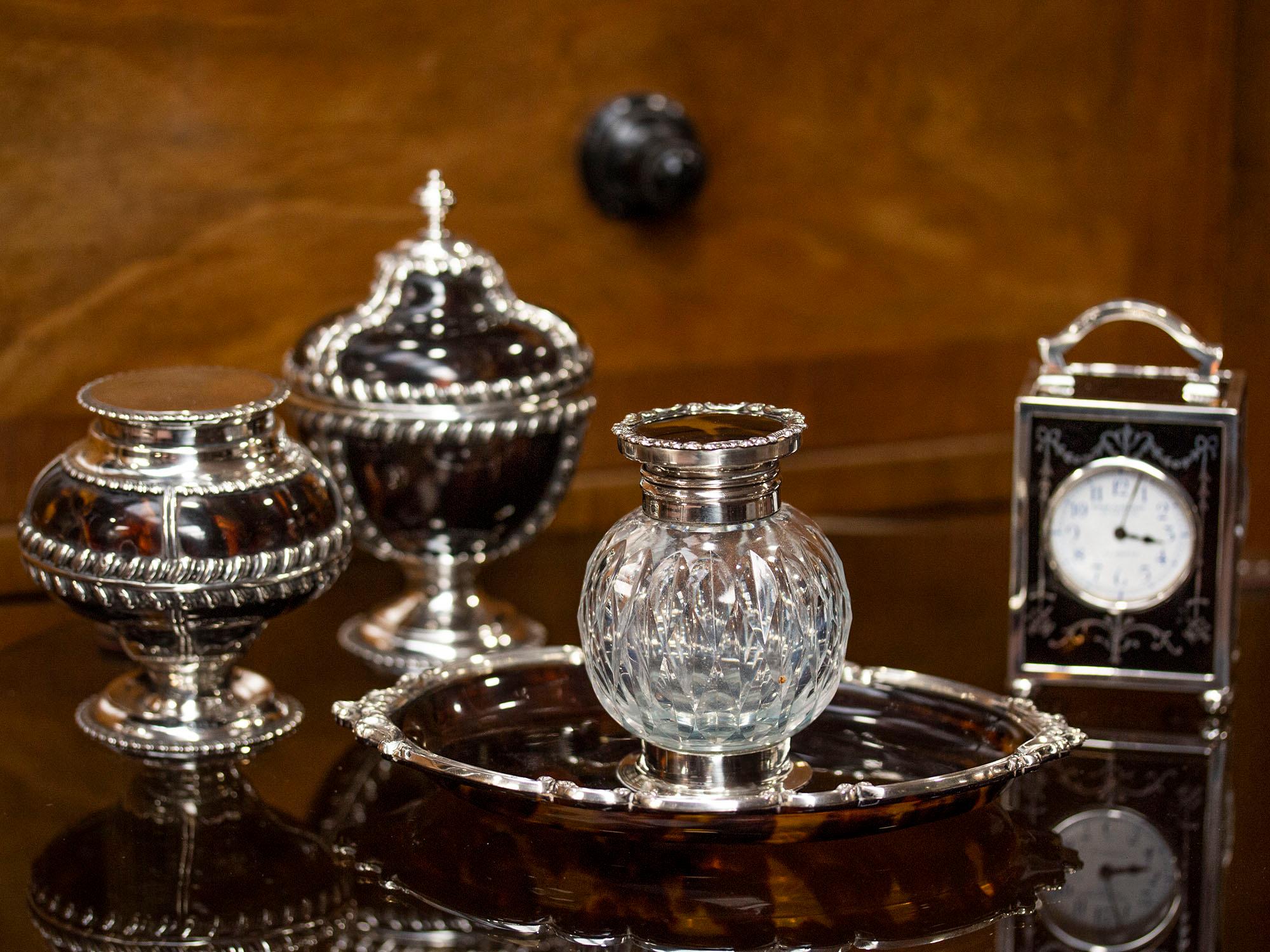 Grey & Co Silver 

From our Accessories collection, we are pleased to offer this Antique English Silver & Tortoiseshell Inkwell. The Inkwell of globular shape with a quilt cut glass body mounted with a circular silver and tortoiseshell lid. The
