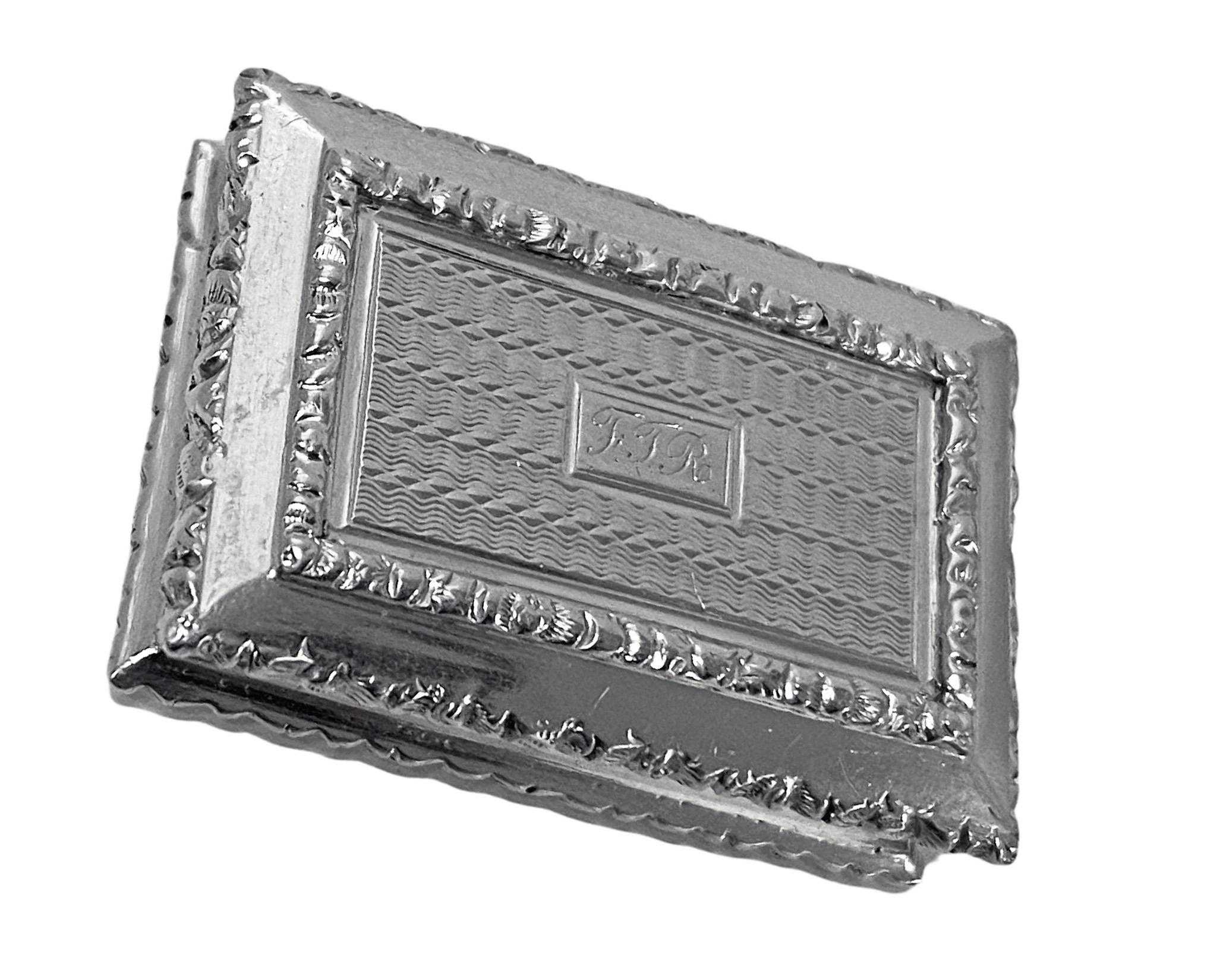 Antique English Silver Vinaigrette Birmingham 1834 G. Wheeler. The rectangular vinaigrette engine turned and foliate borders to cover and base. Interior and pierced grille gilded. Hallmarked on cover, base and grille. light monogram to cover.