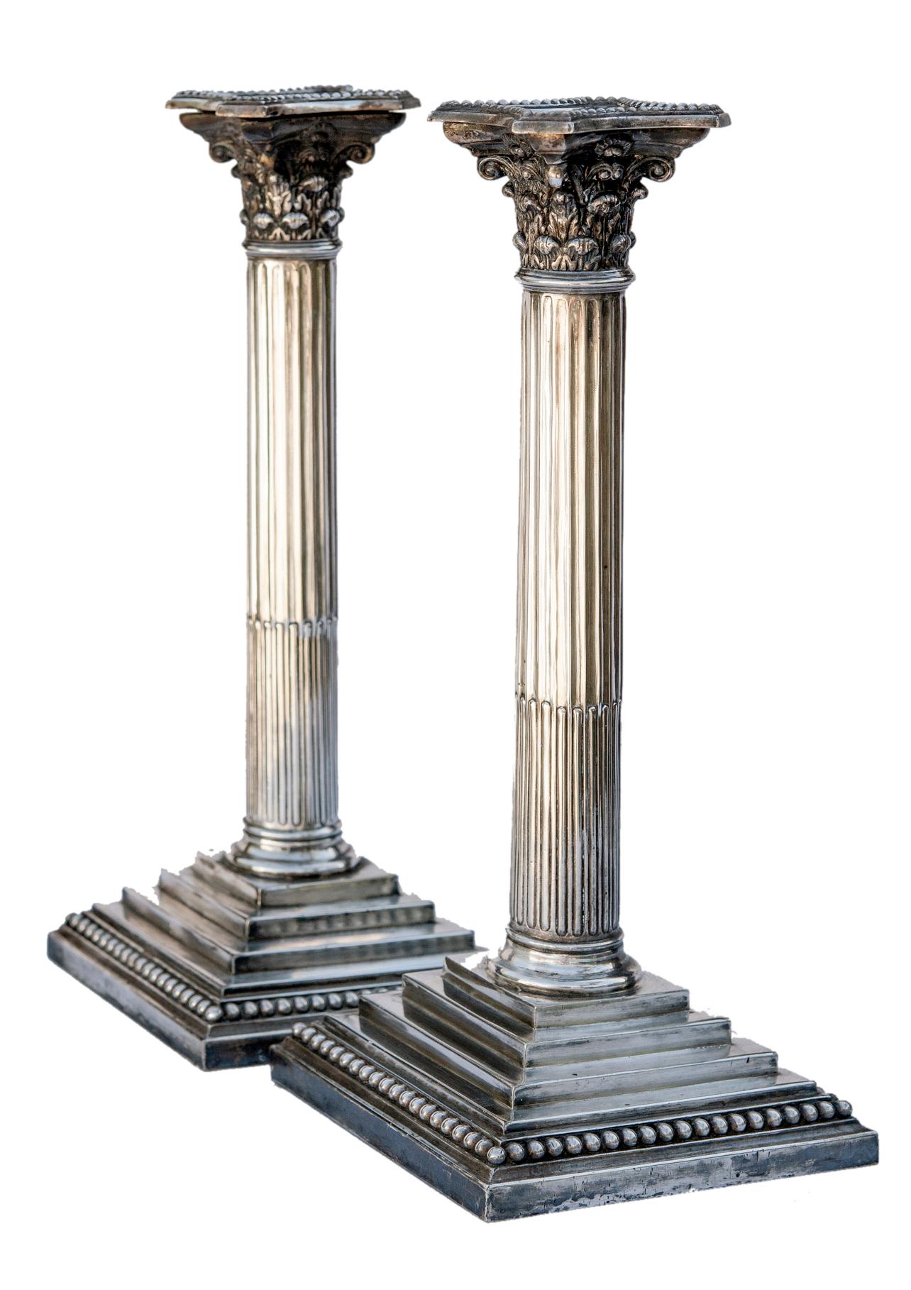 Pair late 19th early 20th century English neoclassical silverplate column candlesticks.
Square bases with steps up to the column. On the square base sits fluted round columns.
Made in Sheffield, UK at a minor boutique silversmith.