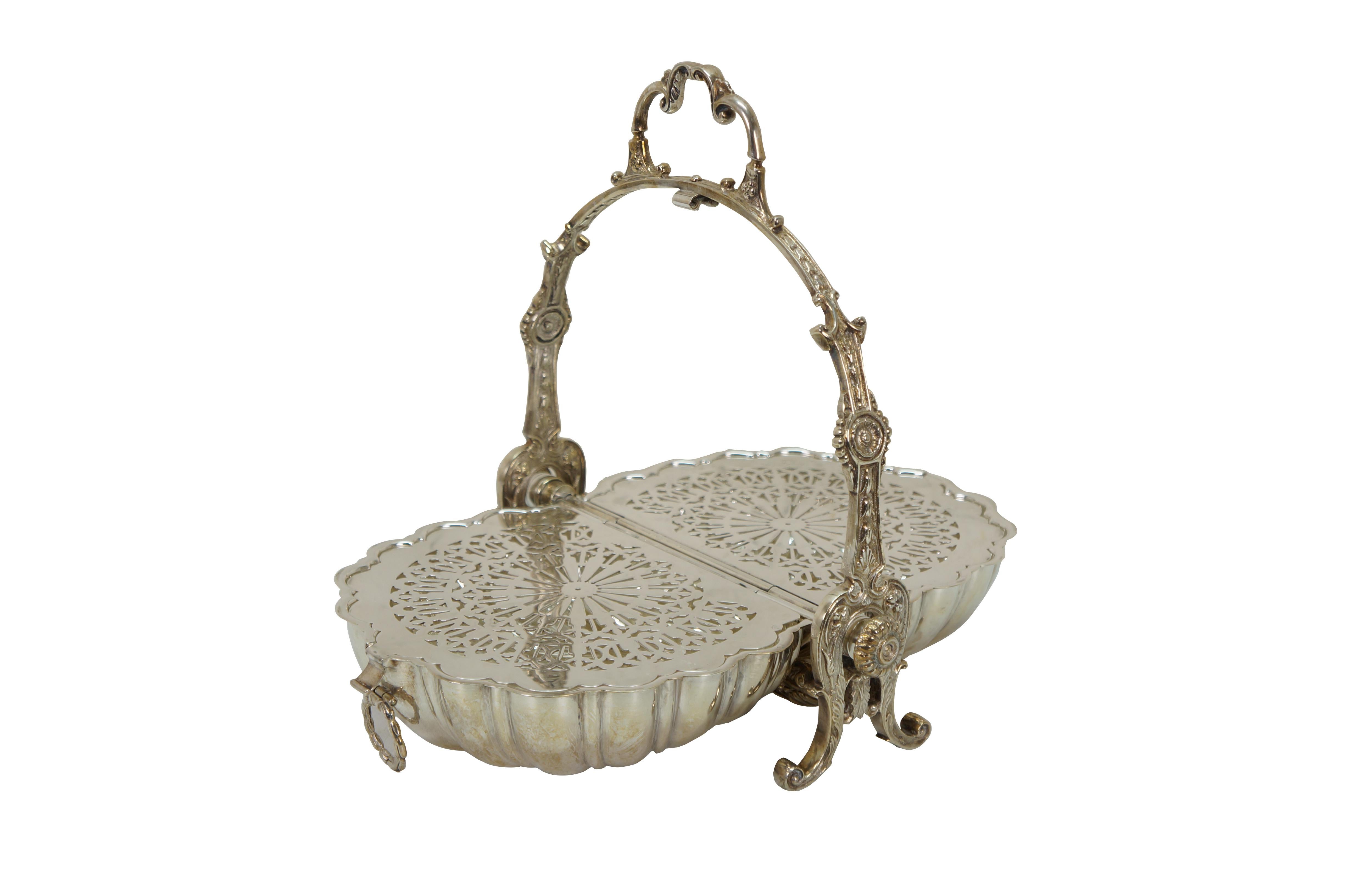 Late 19th to early 20th century victorian / Edwardian silverplate folding biscuit box. double sided clamshell style on a scrolling foliate stand with handle. Each side flips down to pierced tray surfaces over open compartments. Marked EPNS Made in