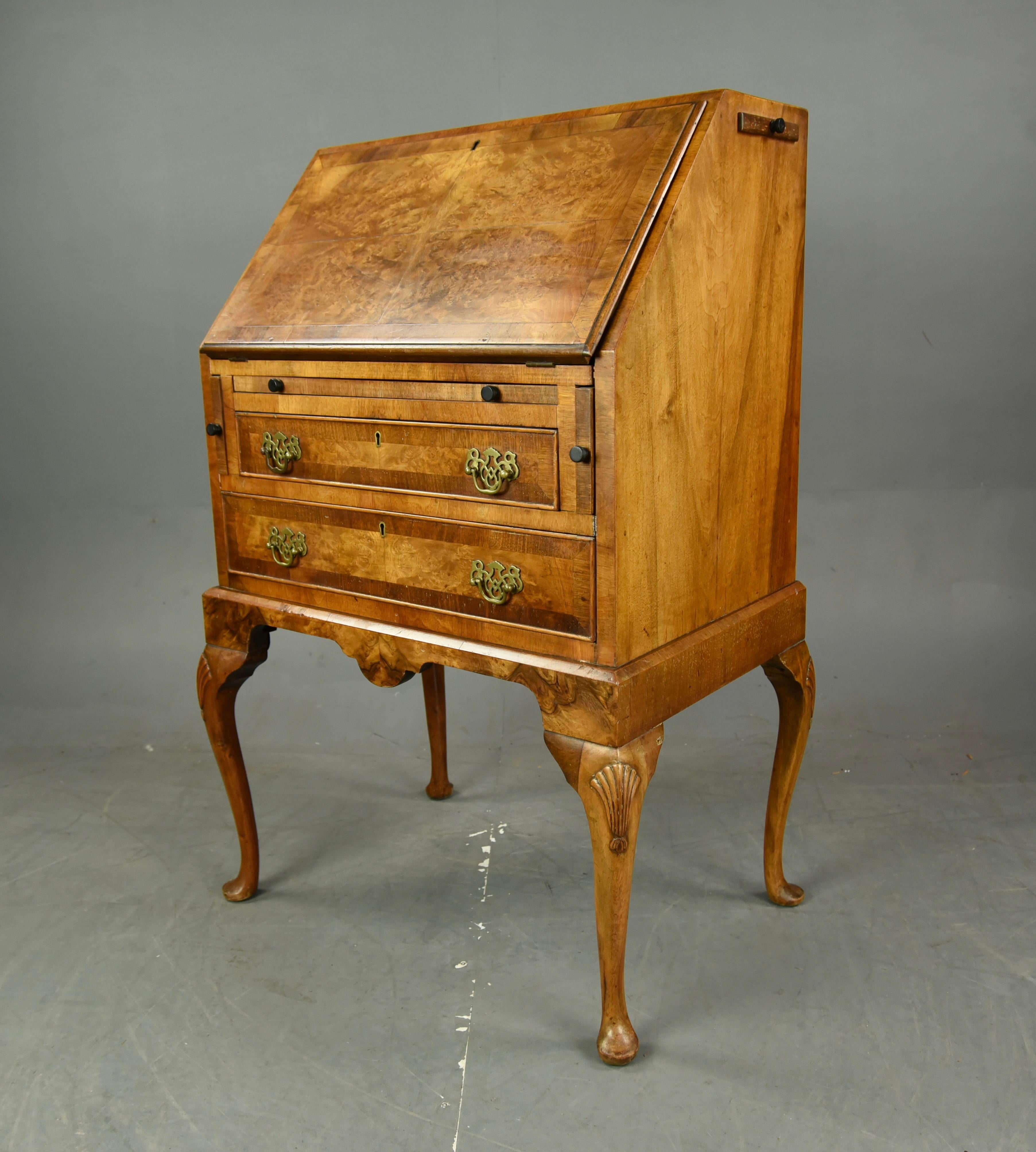 Wonderful small burr walnut Queen Anne style bureau circa 1920.
The bureau is very unusual having a brushing slide and two candle slides.
it is a great colour with a good grain and a nicely fitted interior, standing on elegant carved cabriole legs
