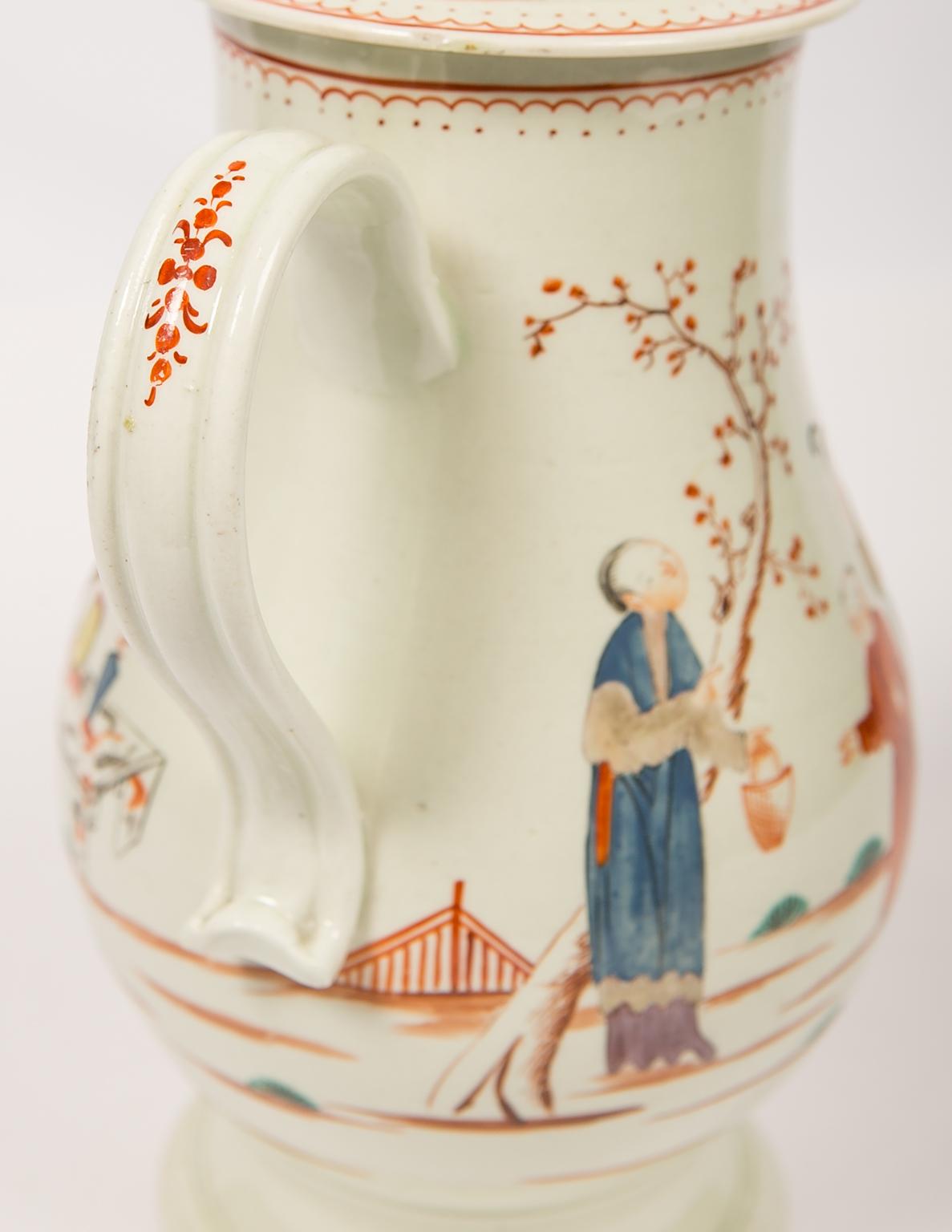 We are pleased to offer this rare Liverpool soft-paste porcelain coffee pot made in England in the late 18th century, circa 1785. 
The pot is painted with a lovely chinoiserie scene on both sides of the body. In the scene, a lady stands in front of