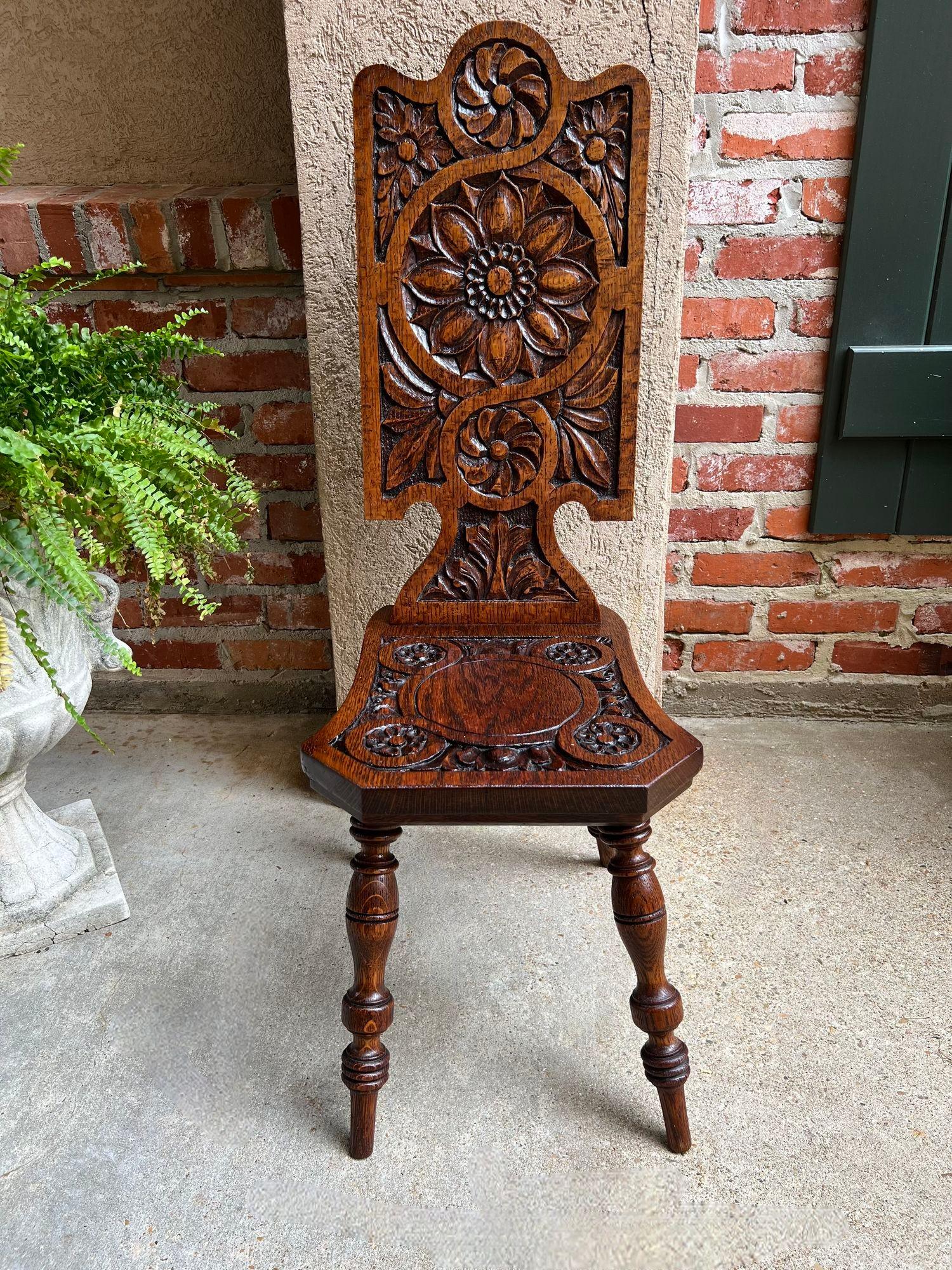 Antique English Spinning Wheel Chair Carved Oak Hall Fireplace Hearth Chair.

Direct from England, a beautiful antique English “spinning wheel” chair with elaborate hand carvings on the seat and back.
The slender, tall back includes a dome top with