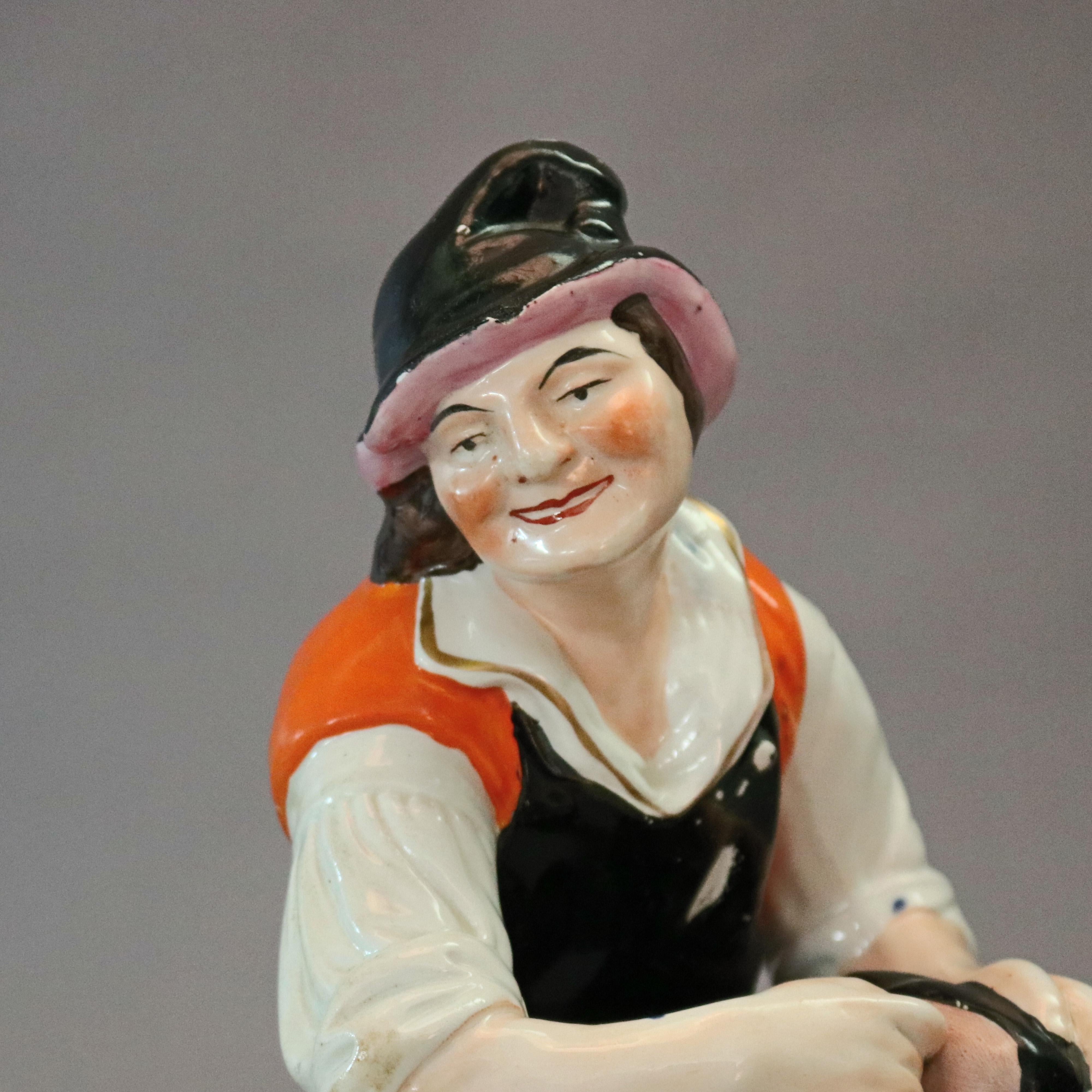 An antique English Staffordshire porcelain figure depicts hand painted cobbler working on shoe seated on covered stool with puppy peeking from beneath, circa 1860


Measures - 12.25