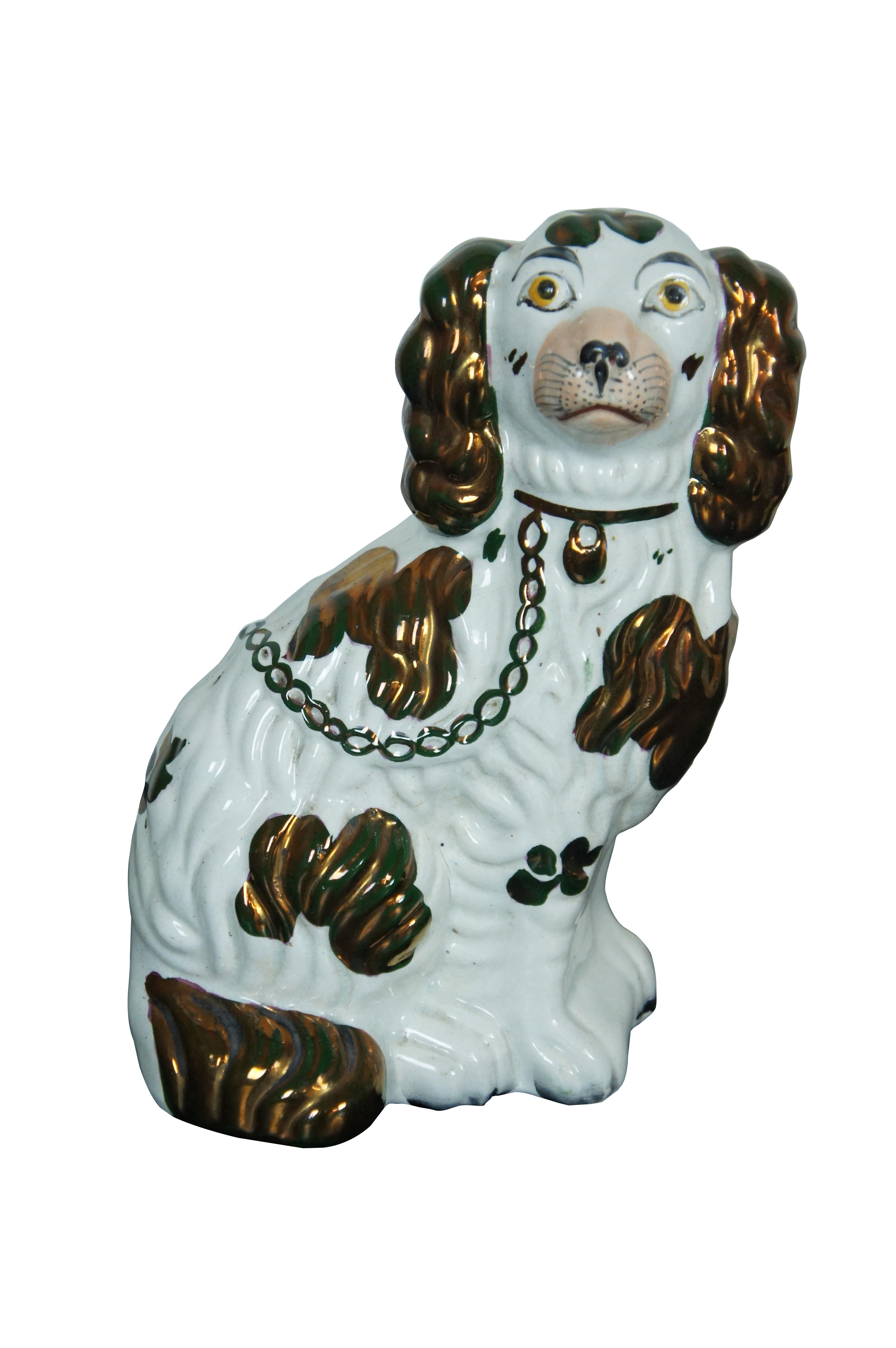 Pair of late 19th century Staffordshire porcelain King Charles Spaniels / mantel dogs. White with painted features and brown lusterware spots, collar, and chain. Molded number 2 on base.

Dimensions:
6.25