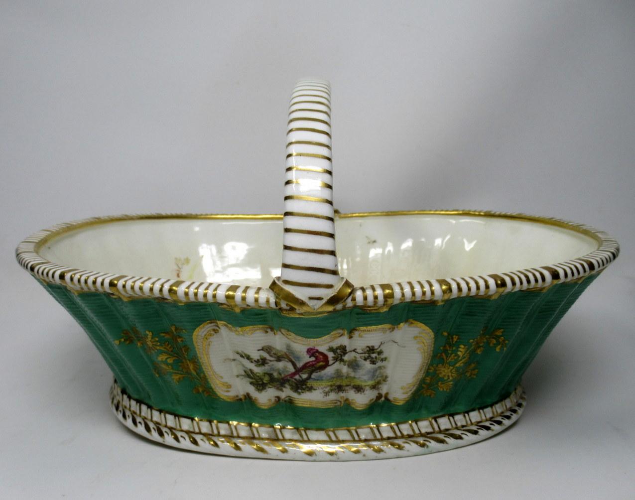 Stylish hand painted single handle fruit basket of oval outline and generous size, possibly by English Royal Worcester or a similar Staffordshire Pottery. Last half of the 19th century.

The main body moulded with a basket weave surface stylishly