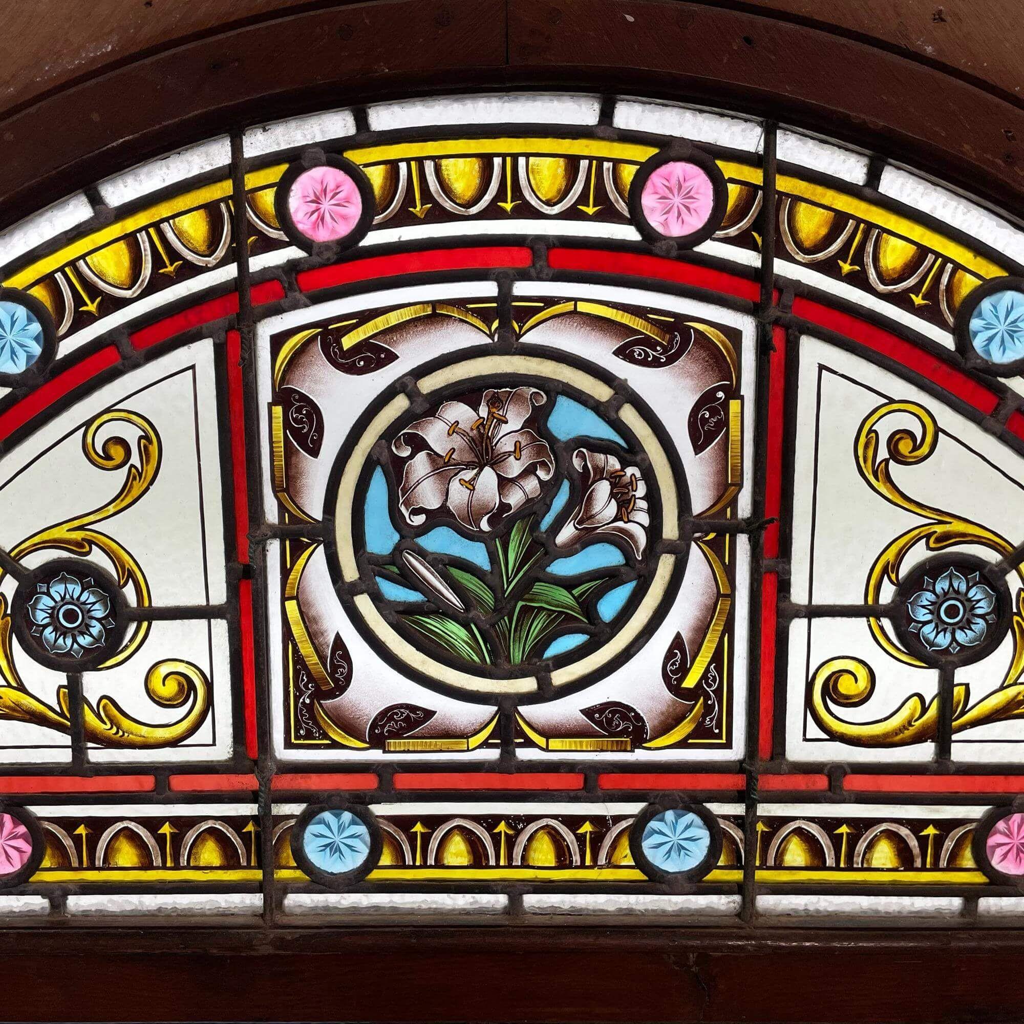 A wonderfully vibrant antique English stained glass fanlight, reclaimed from a hotel in Newquay, UK. Though dating from the late 19th century, this Victorian fanlight will make a stunning feature above a porch or dividing door in properties