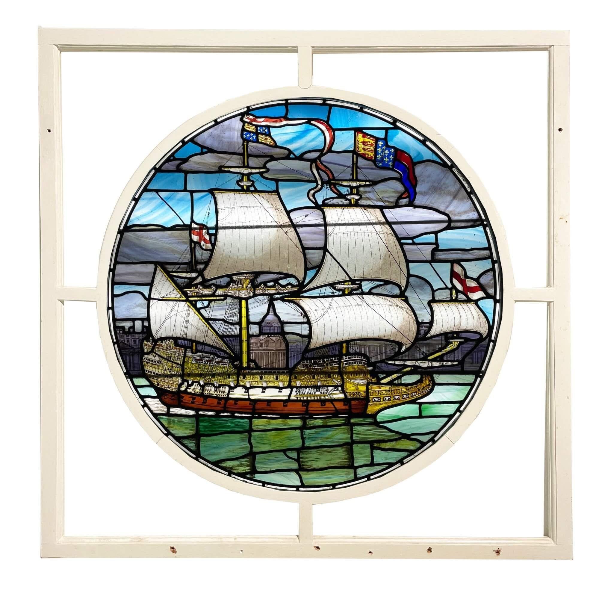 A spectacular large antique English stained glass window depicting a grand masted sailing ship before a view of a city, likely London. Originating from the late 19th century, the stained glass details an 18th century nautical scene 100 – 150 years