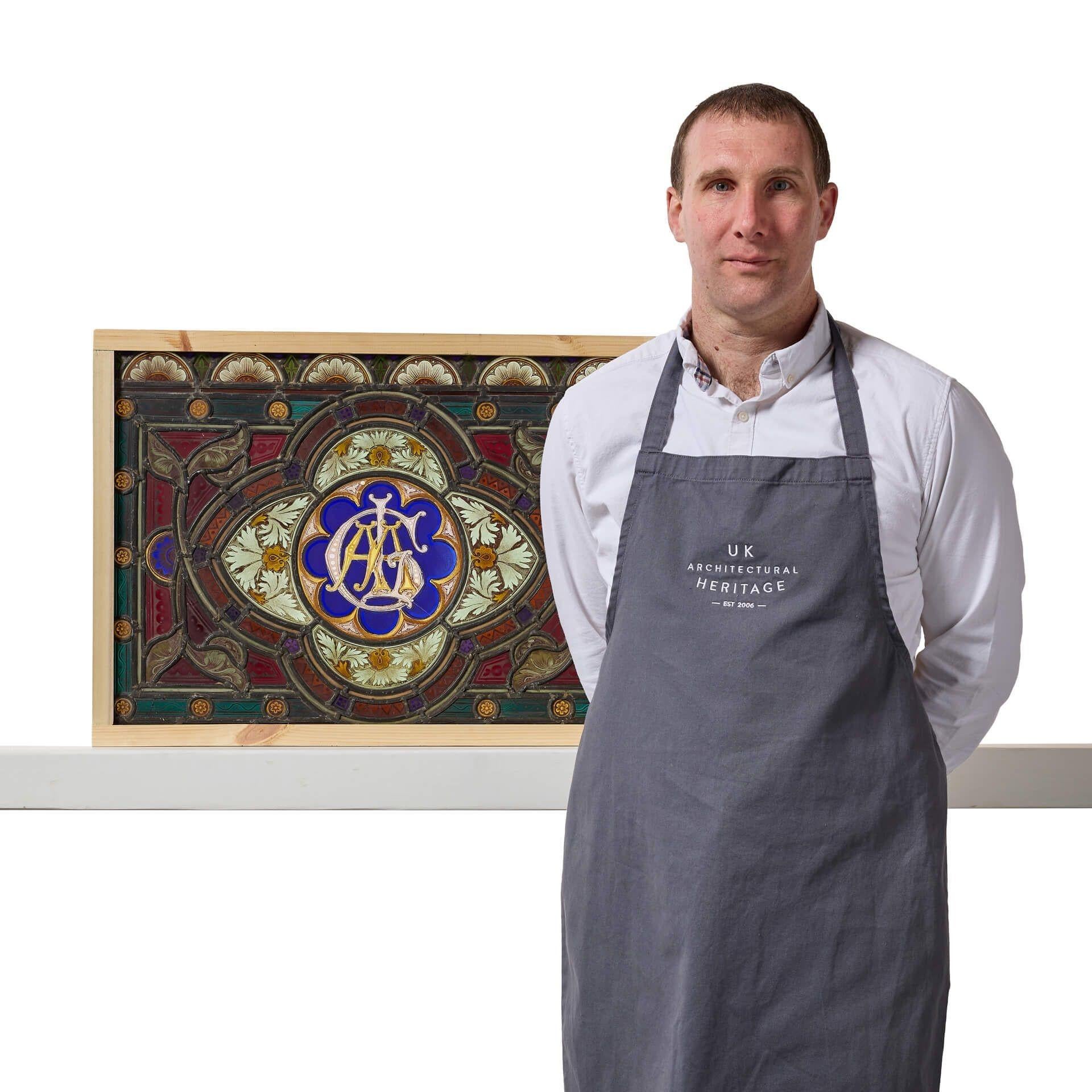 A colourful and highly detailed antique English stained glass window detailed with a monogram of the letters G, L, A and A to the centre. Dating from circa 1870, this stained glass window has stood the test of time, making a stunning historical
