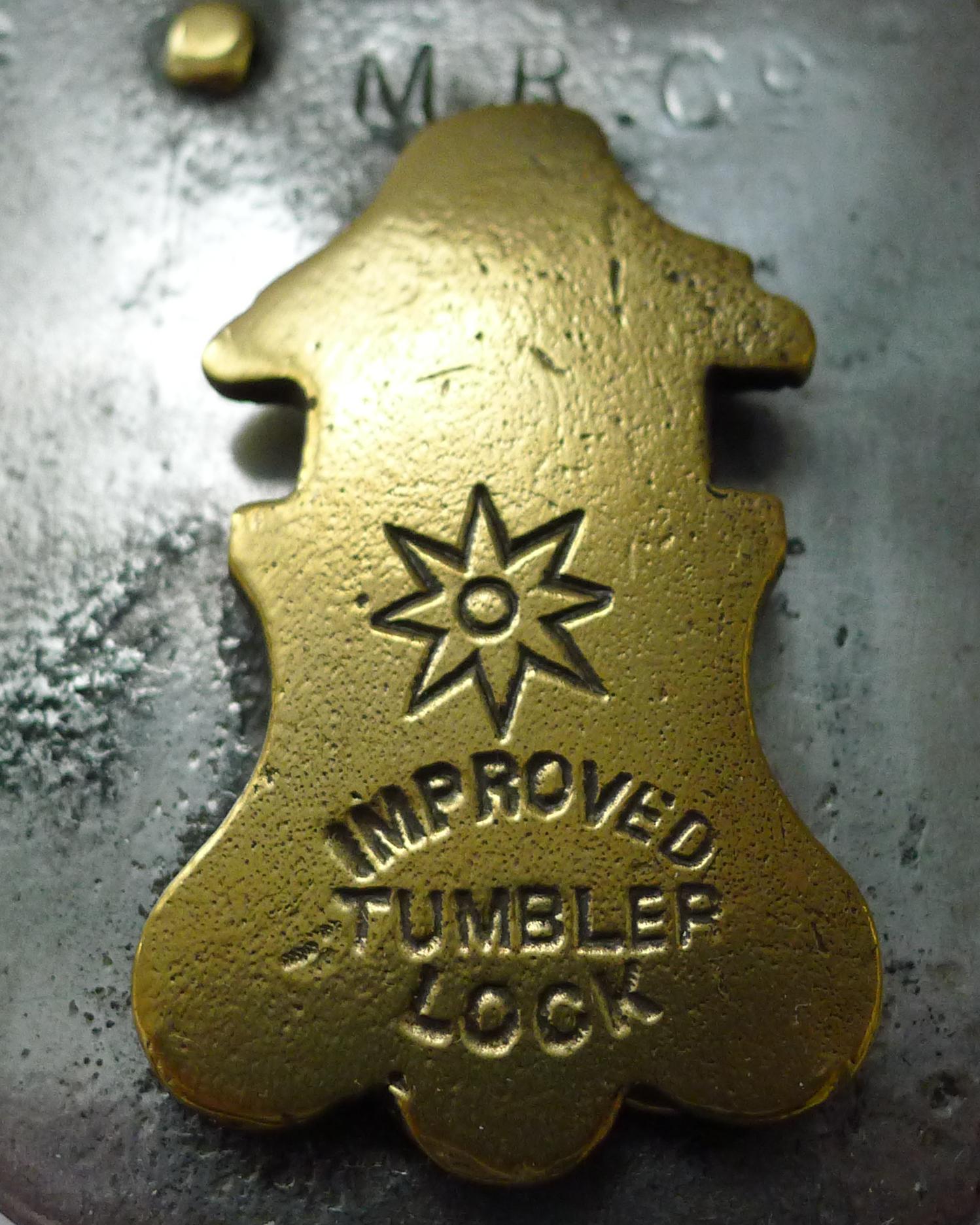 A handsome English Victorian padlock having been professionally cleaned and polish creating a highly decorative object complete with it's large original working key.

The lock is stamped M R Co with the escutcheon cover stamped with a makers mark of