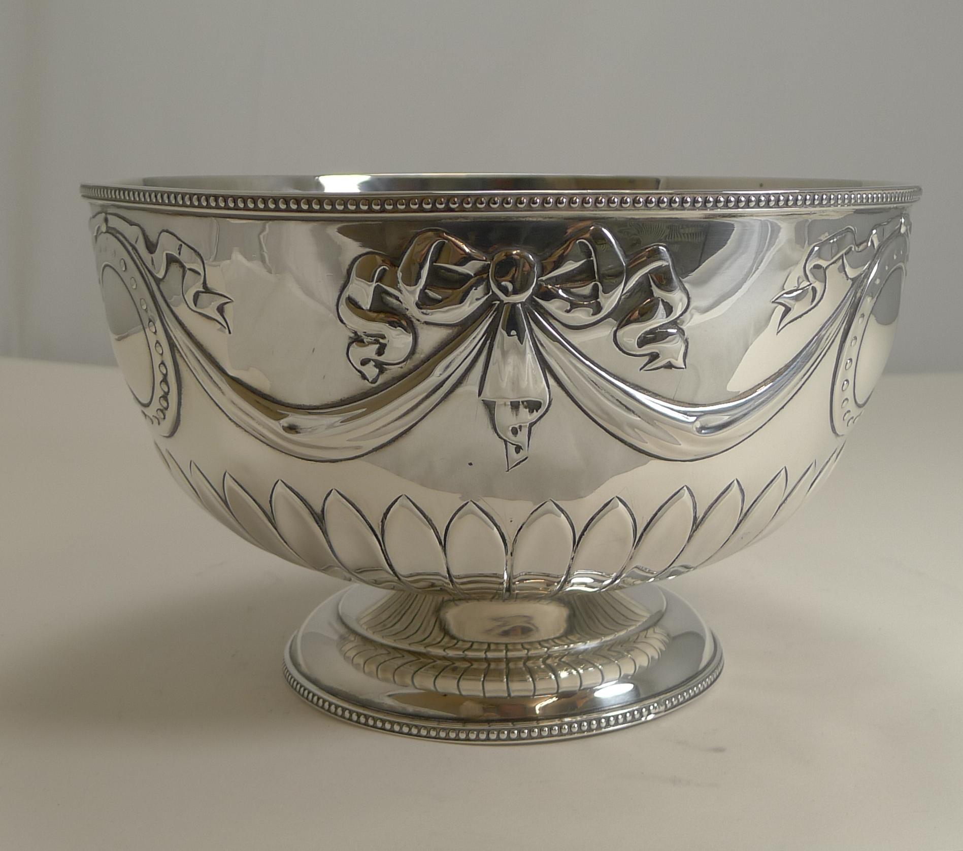 A stunning Edwardian English sterling silver rose bowl, perfect for a variety of uses. The footed bowl is decorated with repousse swags, ribbons & Bows.

The silver is fully hallmarked for London 1904, a true antique example. The makers initials