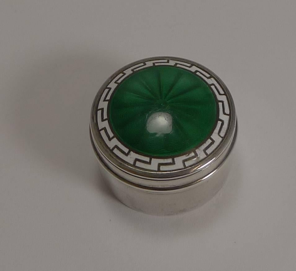 A pretty little box made from English sterling silver with a lift-off lid beautifully decorated with a rich emerald green guilloche enamel to the centre, surrounded with a white enamel Greek Key design.

The box is fully hallmarked for Birmingham