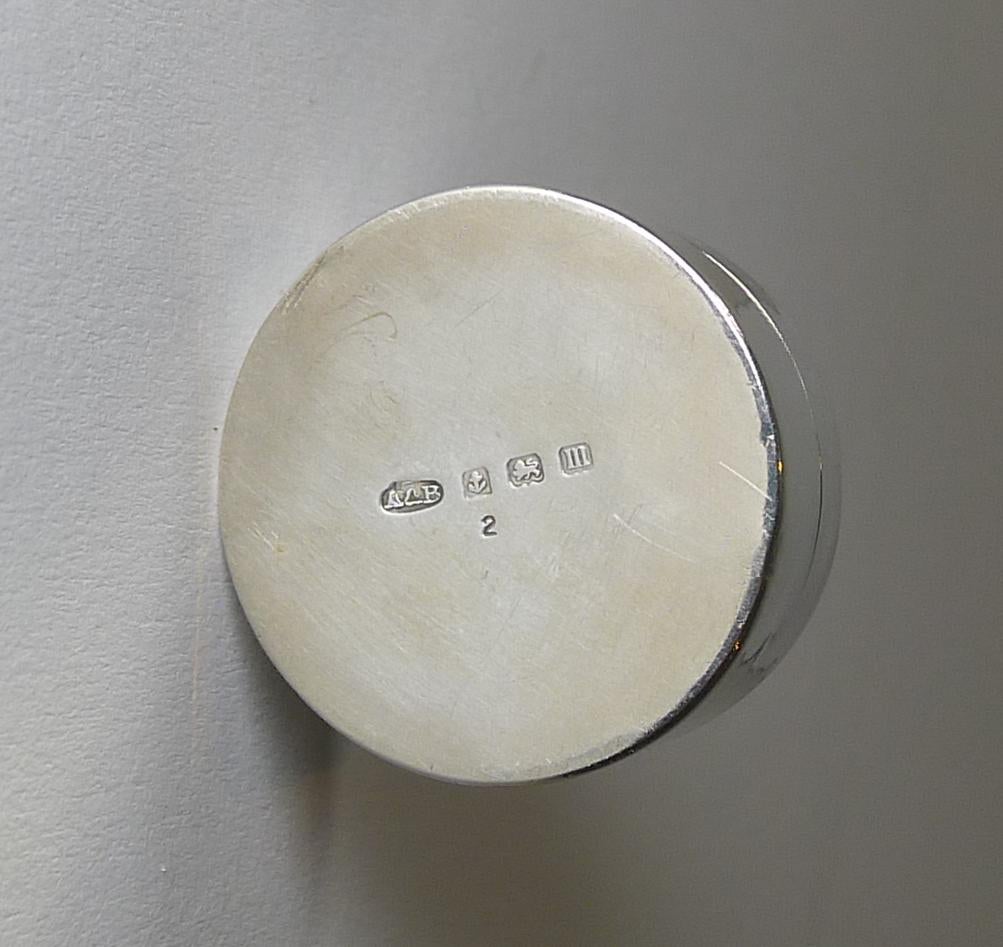 An adorable antique English sterling silver lidded box fully hallmarked on the underside for Birmingham 1911. The lid is domed, enhancing the stunning blue enamel with a bright patina, showcasing the decorative guilloche engraving below.

The