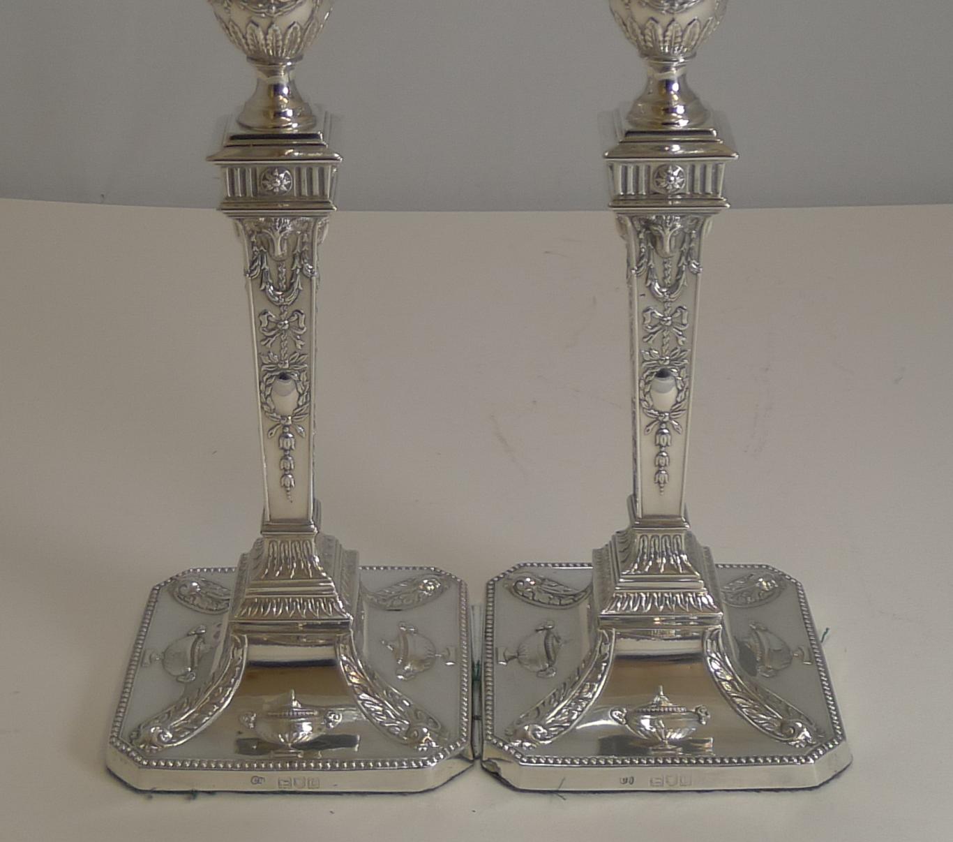 A magnificent pair of late Victorian Adams style candlesticks made from English sterling silver hallmarked for London, 1898.

A highly sought-after design featuring urns to the base, Ram's heads to all four sides of the columns. The drip trays are