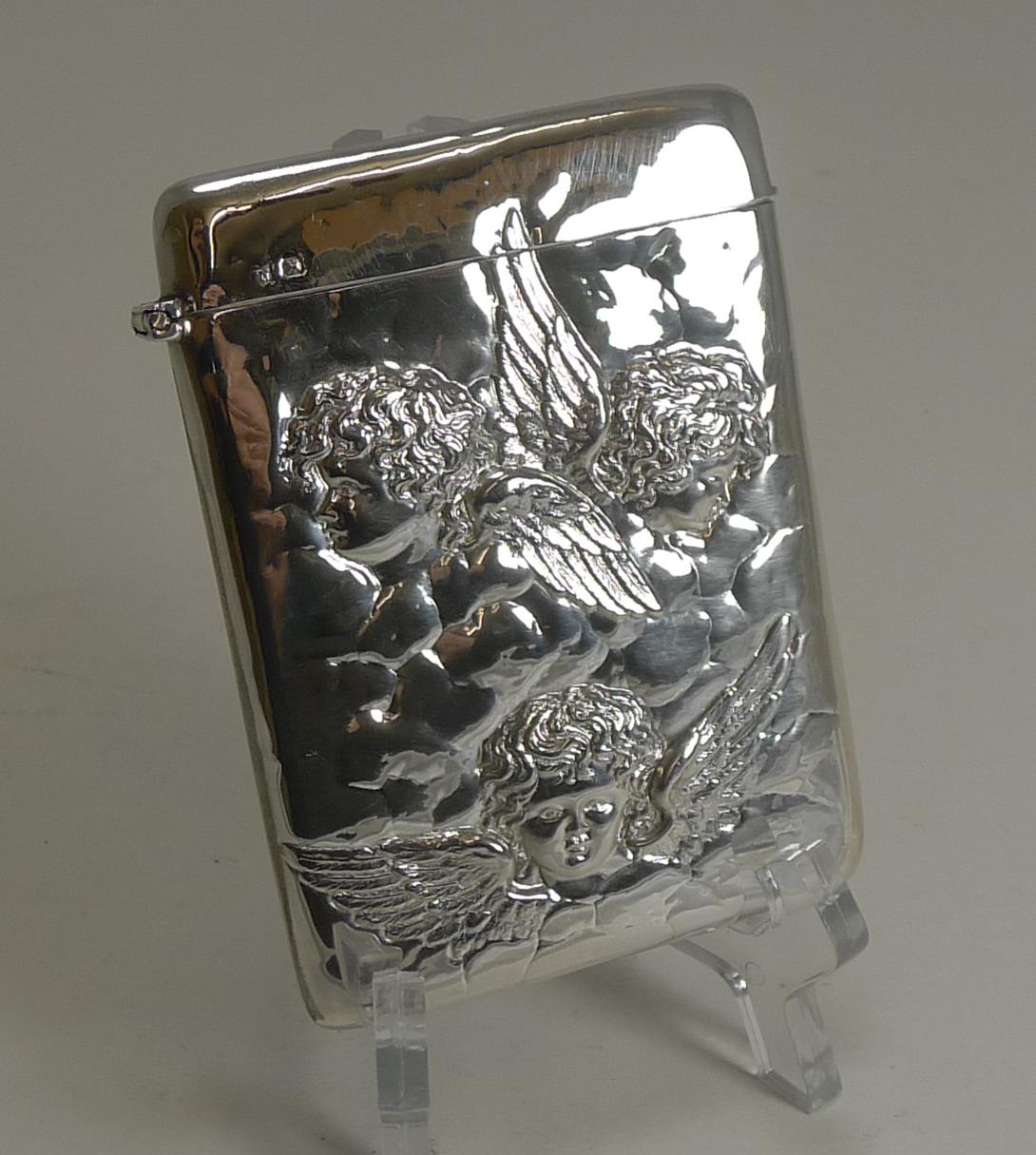 A wonderful solid sterling silver card case, the front featuring three adorable angels or winged cherub / putti figures, among the clouds.

The hinge lid works well, this is where the full English hallmark can be found for Sheffield 1898, a true