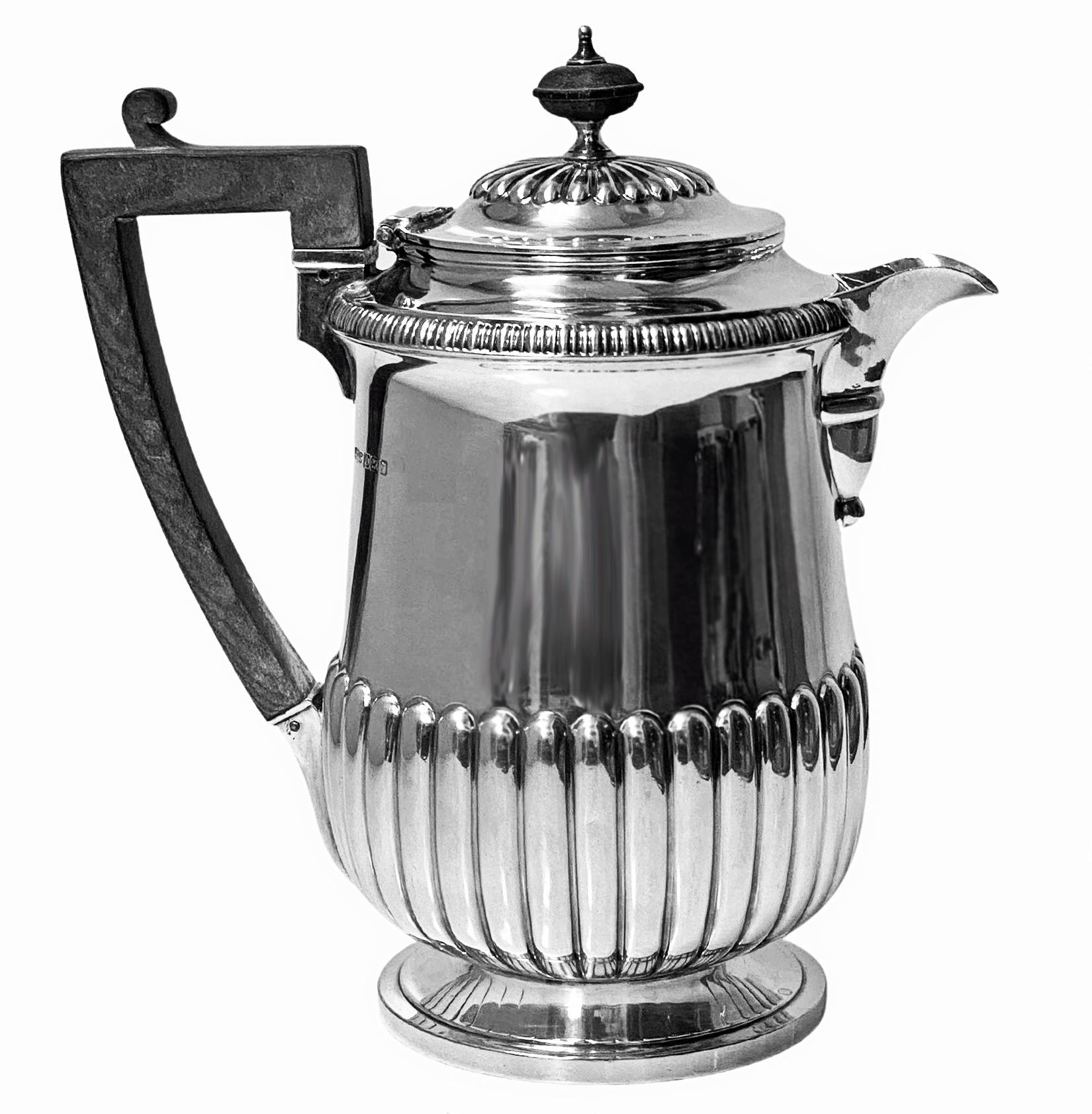 Antique Silver Coffee Pot or Biggin, hallmarked Sheffield 1909, James Dixon & Sons. The Jug of early 19th century Georgian style, on small circular plain moulded pedestal base, slightly wasted lower fluted body, upper body plain with gadroon rim,
