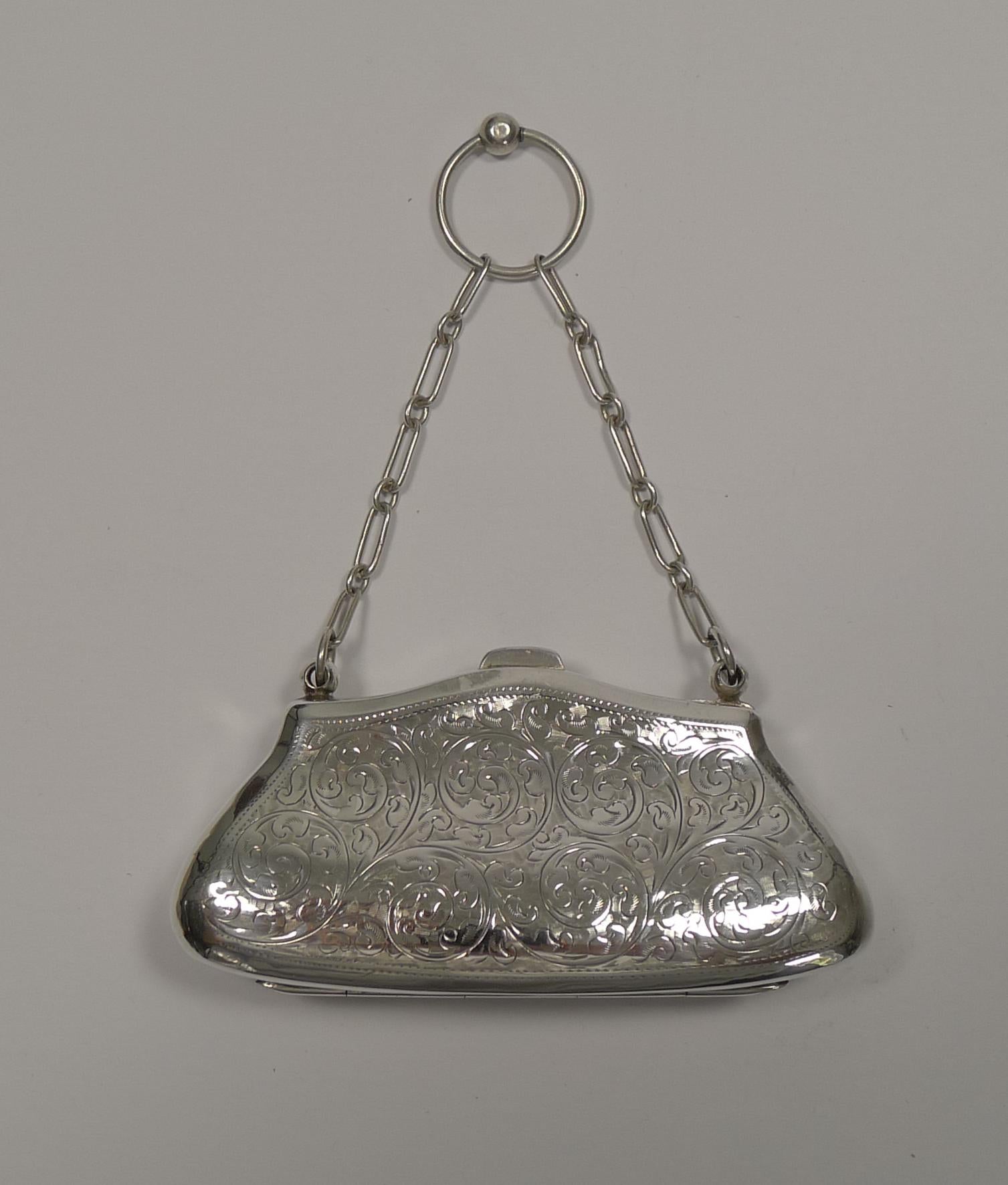 A wonderful and very elegant coin purse, made from English Sterling silver fully hallmarked for Birmingham 1913; the makers mark is also present for the silversmith, Joseph Cook & Son Ltd.

The front is decorated with engraving surrounding a