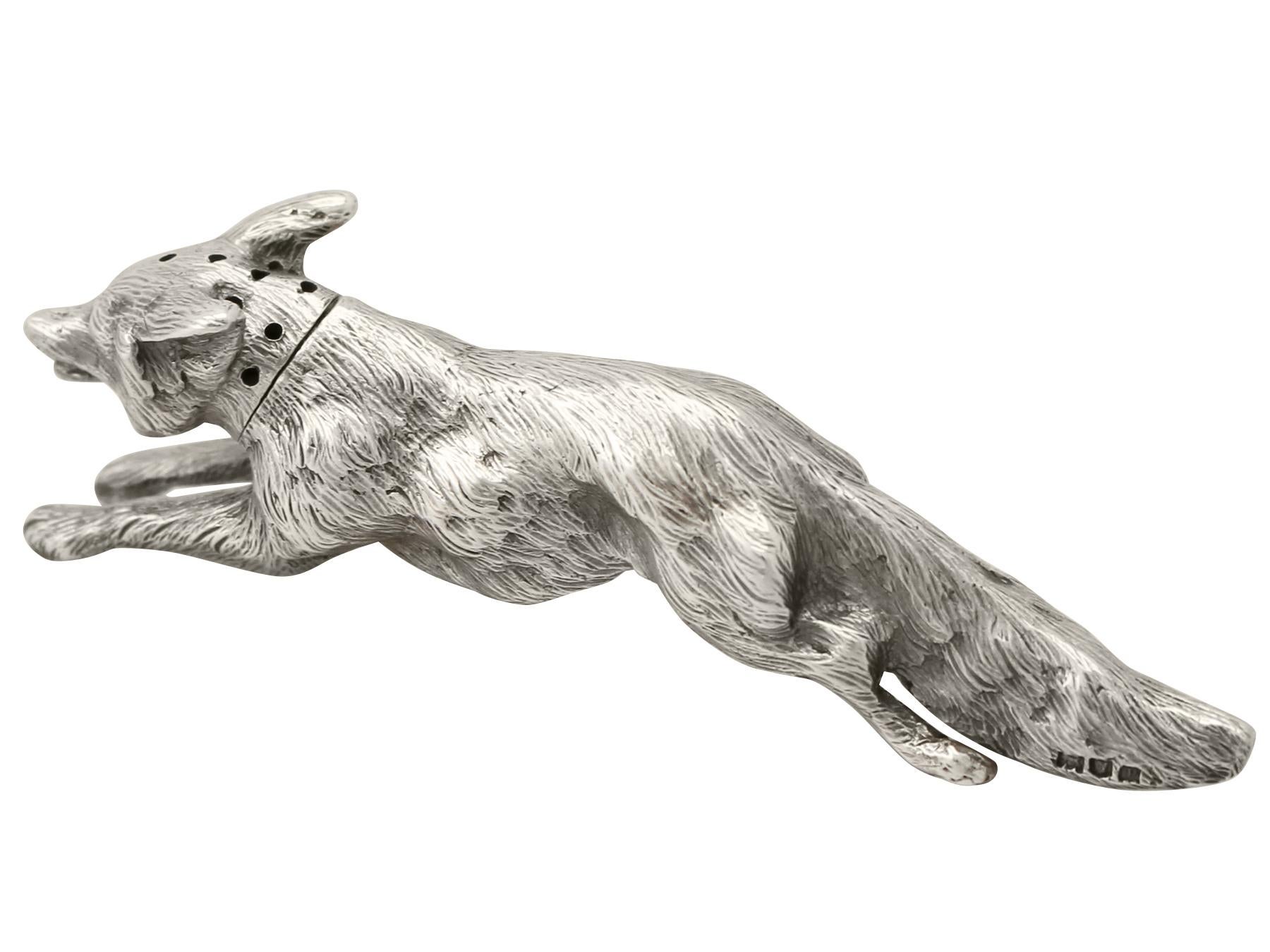 An exceptional, fine and impressive antique George V English cast sterling silver pepperette in the form of a fox; an addition to our animal related silverware collection.

This exceptional antique George V cast sterling silver pepperette has been