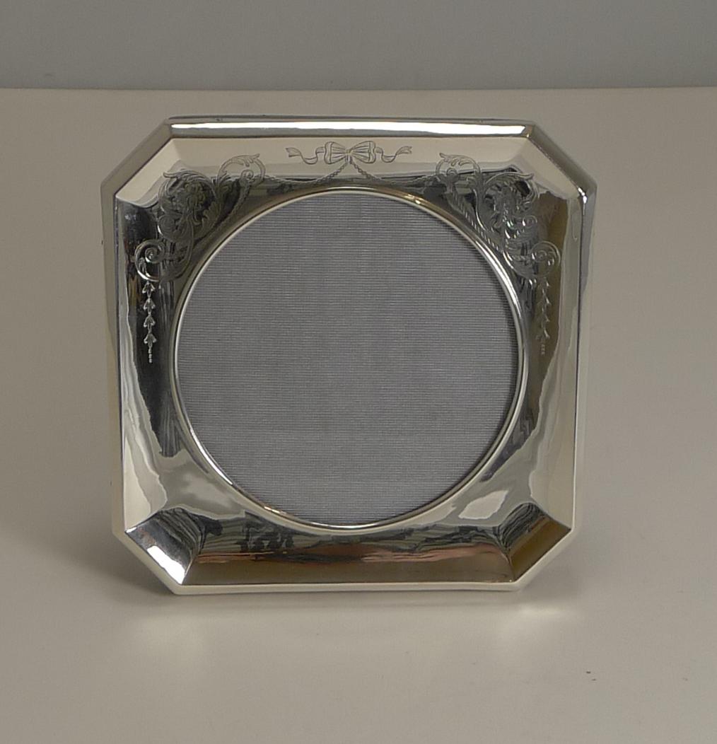 Pretty as a picture, this is a wonderfully square shaped frame with a circular glazed aperture. Above the aperture is an extremely pretty engrave ribbon and bow engraved garland decoration.

The frame is backed with solid English oak with a