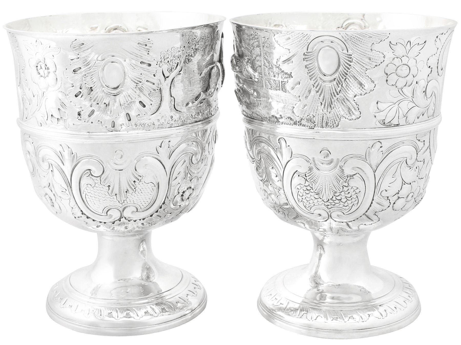An exceptional, fine and impressive composite pair of antique English sterling silver presentation cups; an addition to our ornamental silverware collection.

These exceptional antique sterling silver presentation cups have a bell shaped form onto