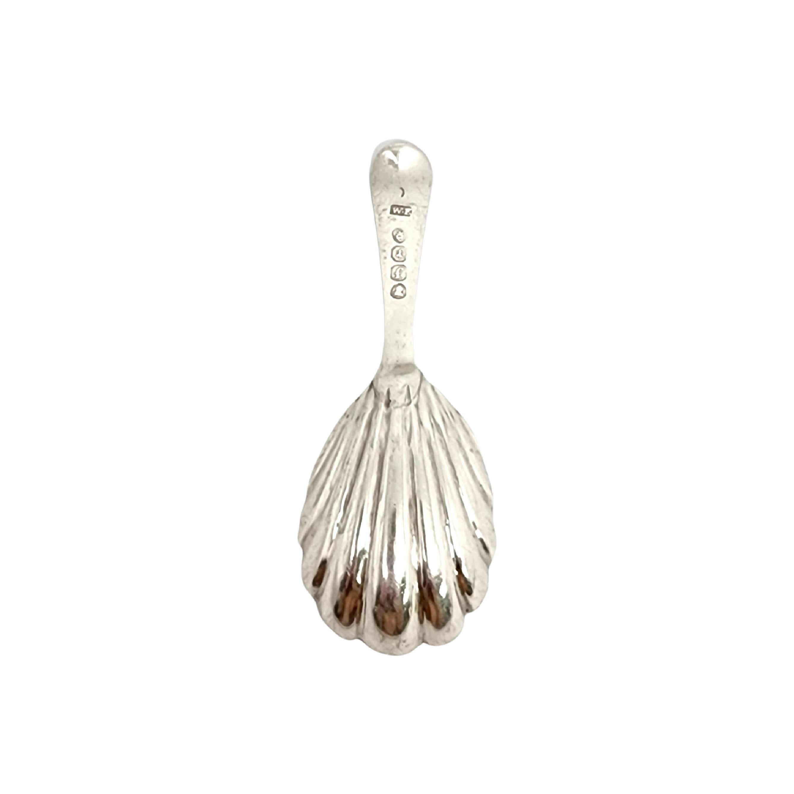 Antique sterling silver tea caddy spoon from London, England, circa 1821.

A scallop shell bowl with a bright cut design handle. No monogram.

Measures approx 3 3/4