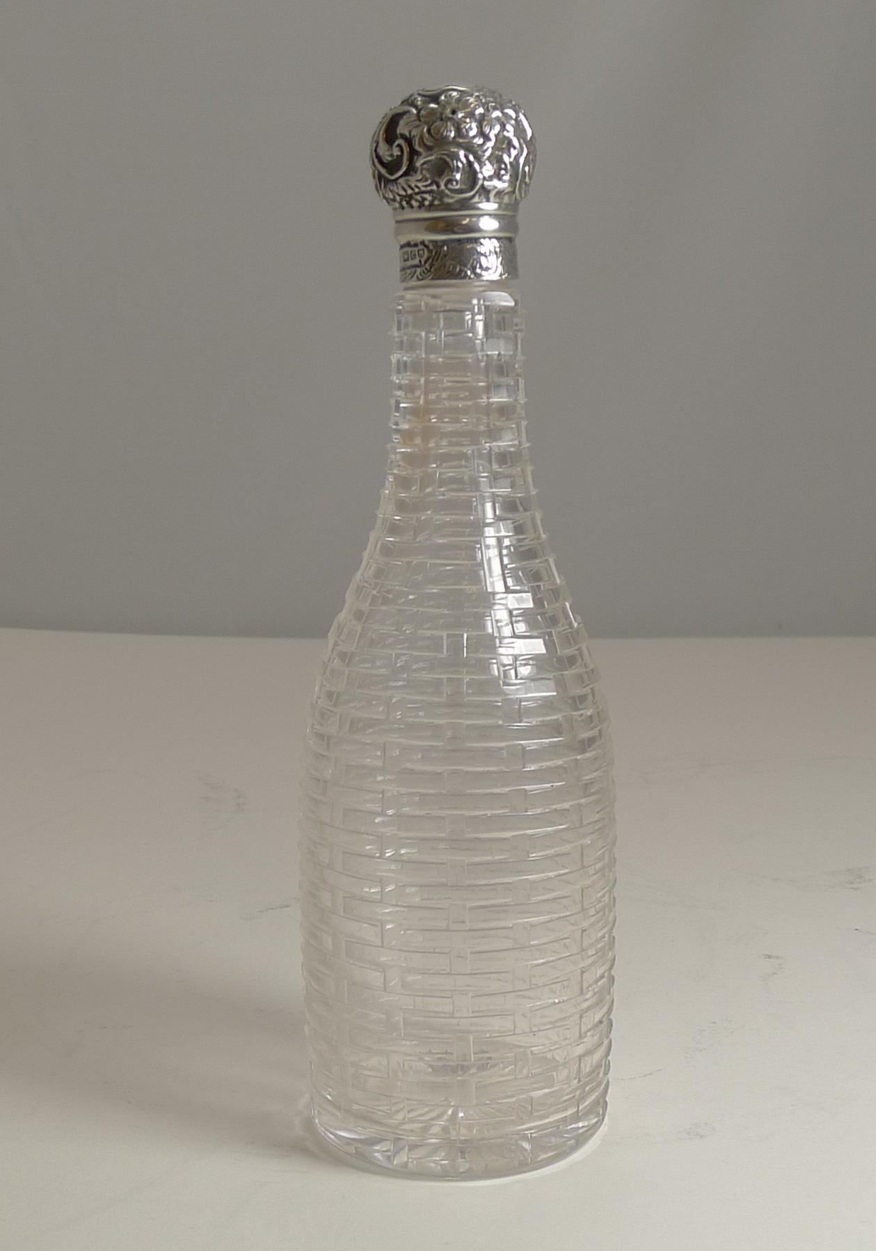 A Wonderful and most unusual miniature Champagne / wine / liquor bottle made from English crystal and handcut to resemble basket weave, outstanding work and without damage.

The sterling silver top is fully hallmarked for London 1898, so a true