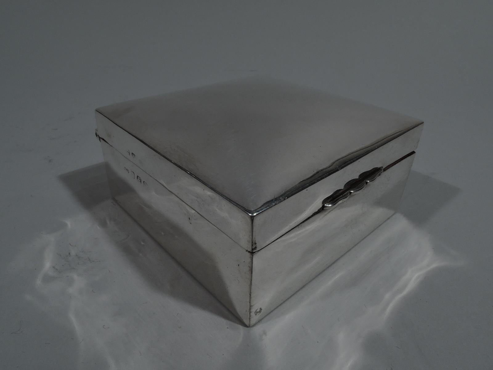 George V sterling silver trinket box. Made by Deakin & Francis in Birmingham in 1921. Rectangular with straight sides. Cover hinged and curved with scrolled tab. Box and cover interior cedar lined. Box underside leather lined. Fully marked. Gross
