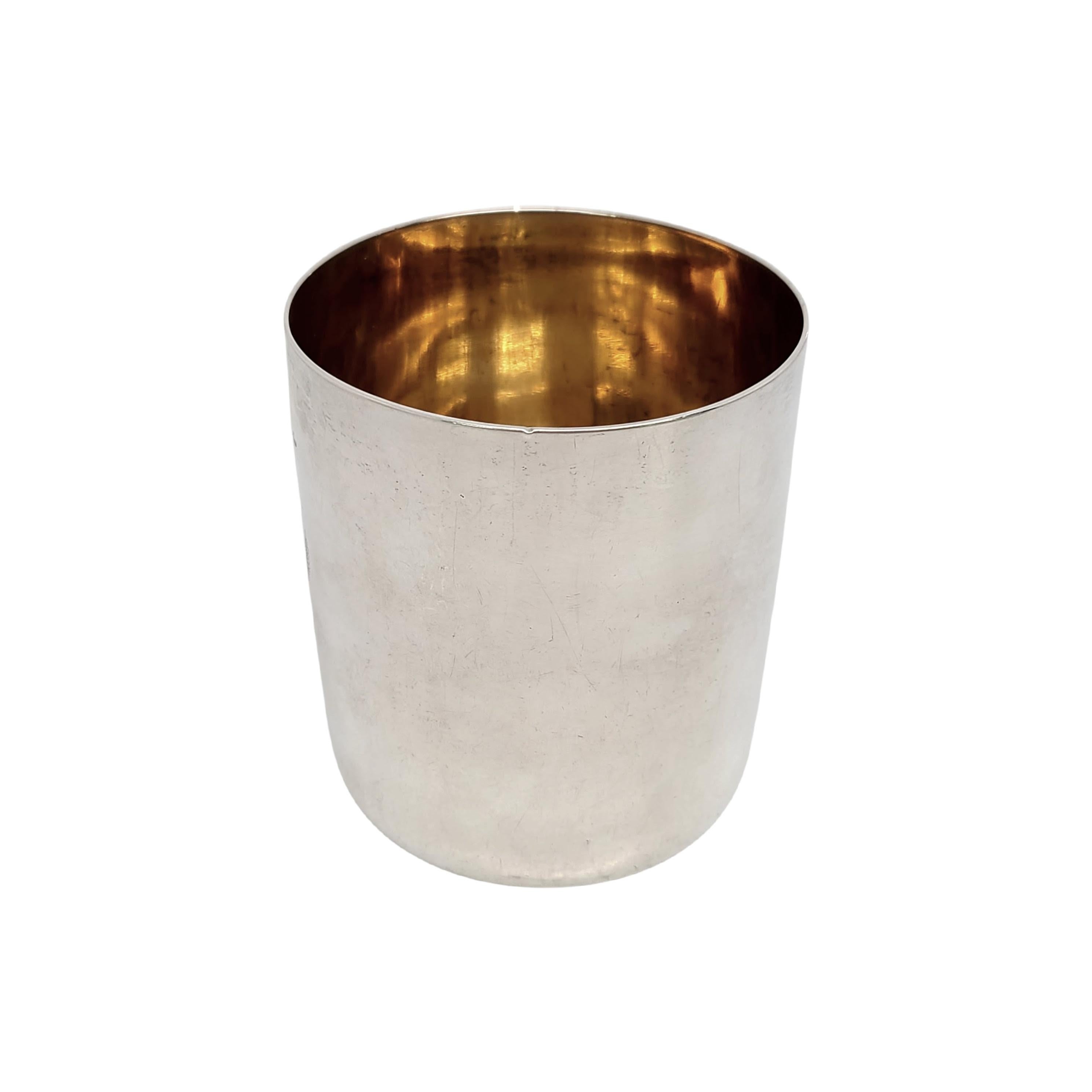 Sterling silver tumbler cup from London, England, circa 1809.

No monogram or engraving.

This simple and elegant tumbler features a highly polished finish and gold wash interior. Engraved with a crowned horse holding a sword sitting atop a crown 
