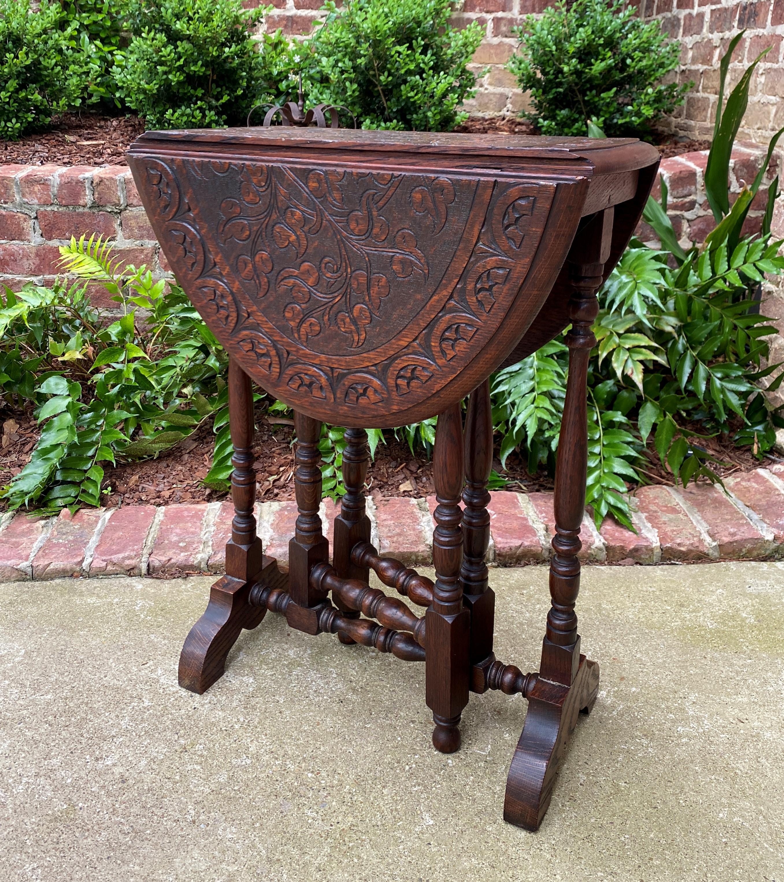 Charming Antique English oak drop leaf gateleg oval table~~carved top~~trestle base~~c. 1920s 

 Always in high demand~~hard-to-find drop leaf table with turned post legs and trestle base.

 Solid and sturdy~~very nice oak patina.

 Versatile