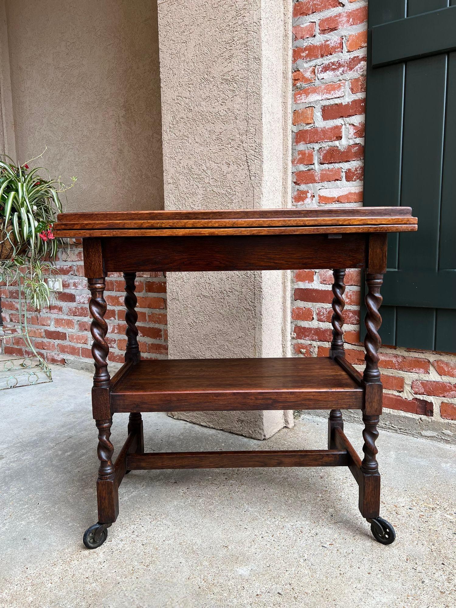 Antique English tea trolley bar drinks cart oak barley twist flip top game table.

Direct from England, a beautiful antique English oak tea trolley or “dumbwaiter” drinks serving cart. Excellent for entertaining, as a drinks or dessert cart, and