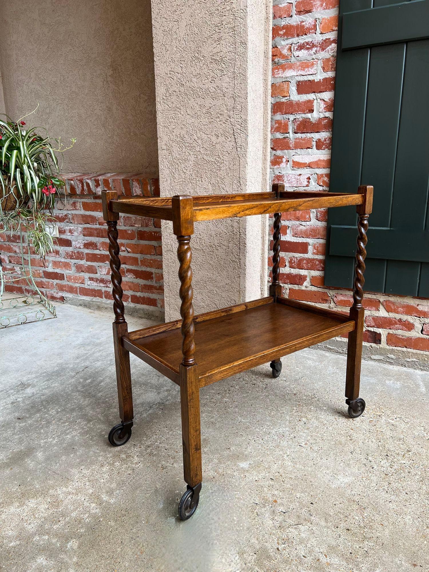 Antique English tea trolley drinks cart tiger Oak Barley twist cocktail table.

 Direct from England, a beautiful antique English oak tea trolley or “dumbwaiter” drinks serving cart. Excellent for entertaining, as a drinks or dessert cart, and