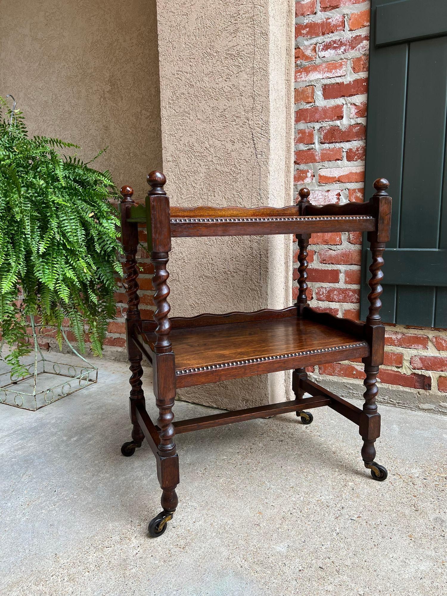 Antique English Tea Trolley Drinks Cart Tiger Oak Barley Twist Cocktail Table.

Direct from England, a beautiful antique English oak tea trolley or “dumbwaiter” drinks serving cart. Excellent for entertaining, as a drinks or dessert cart, and