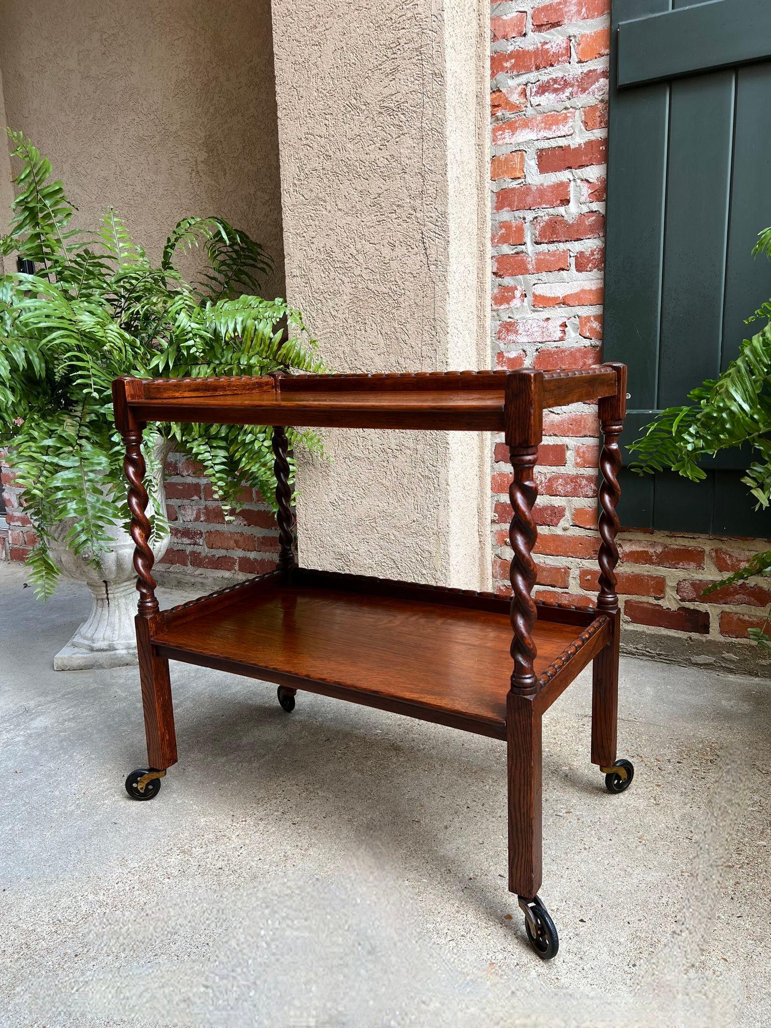Antique English Tea Trolley Drinks Cart Tiger Oak Barley Twist Cocktail Table.

Direct from England, a beautiful antique English oak tea trolley or “dumbwaiter” drinks serving cart. Excellent for entertaining, as a drinks or dessert cart, and great