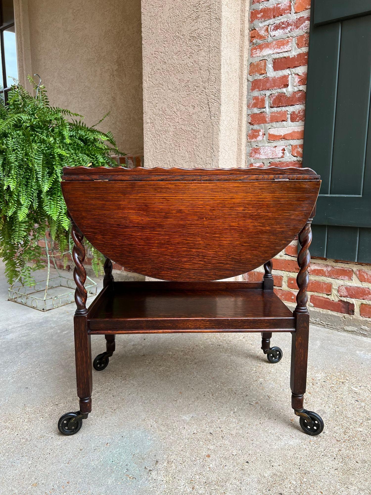 Antique English Tea Trolley Drinks Cart Tiger Oak Barley Twist Drop Leaf Table.

Direct from England, another beautiful antique English oak tea trolley or “dumbwaiter” drinks serving cart. 
Excellent for entertaining, as a drinks or dessert cart,