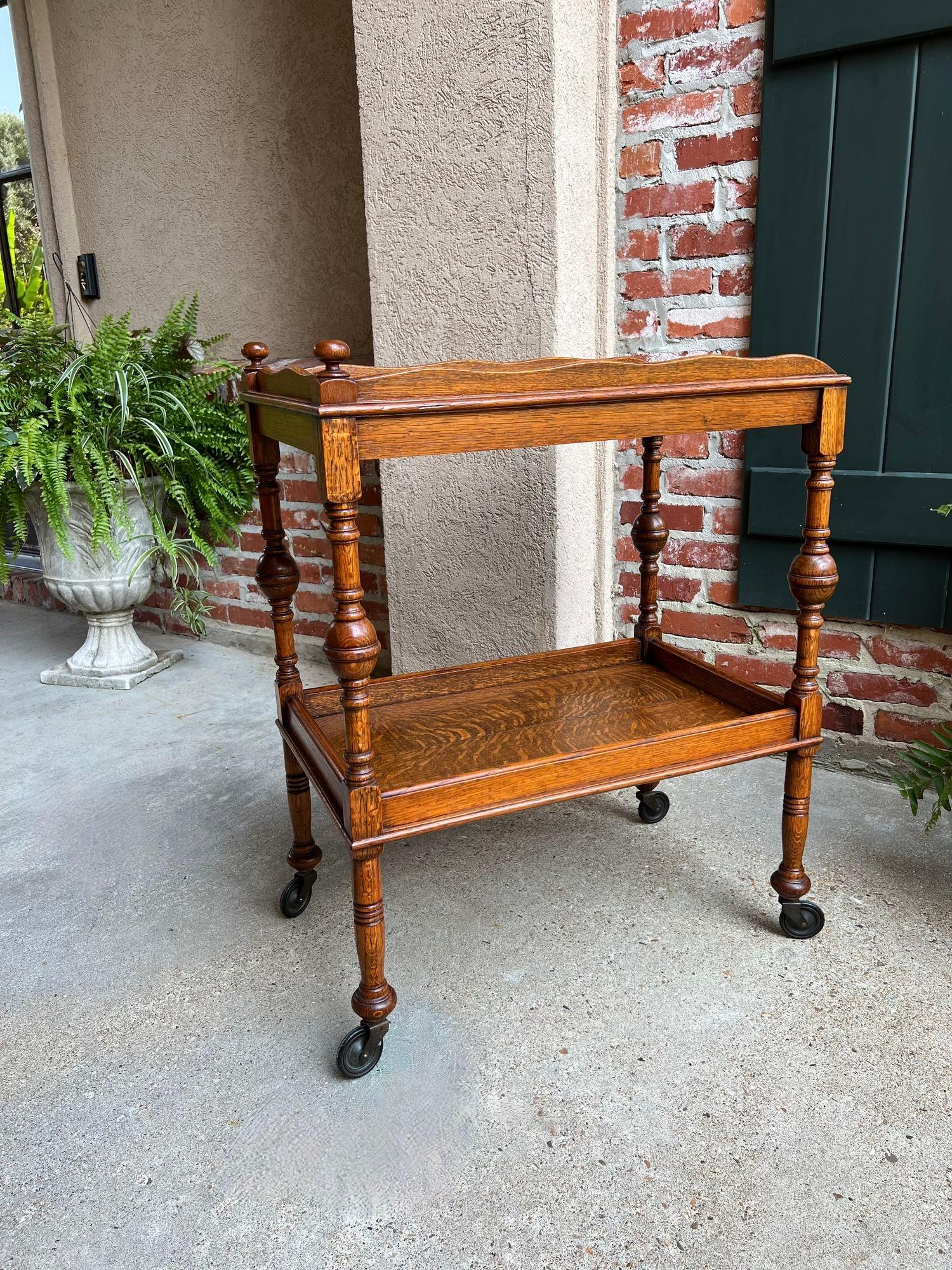 Antique English Tea Trolley Drinks Cart Tiger Oak British Rolling Cocktail Table.

Direct from England, a beautiful antique English oak tea trolley or “dumbwaiter” drinks serving cart. 
Excellent for entertaining, as a drinks or dessert cart, and