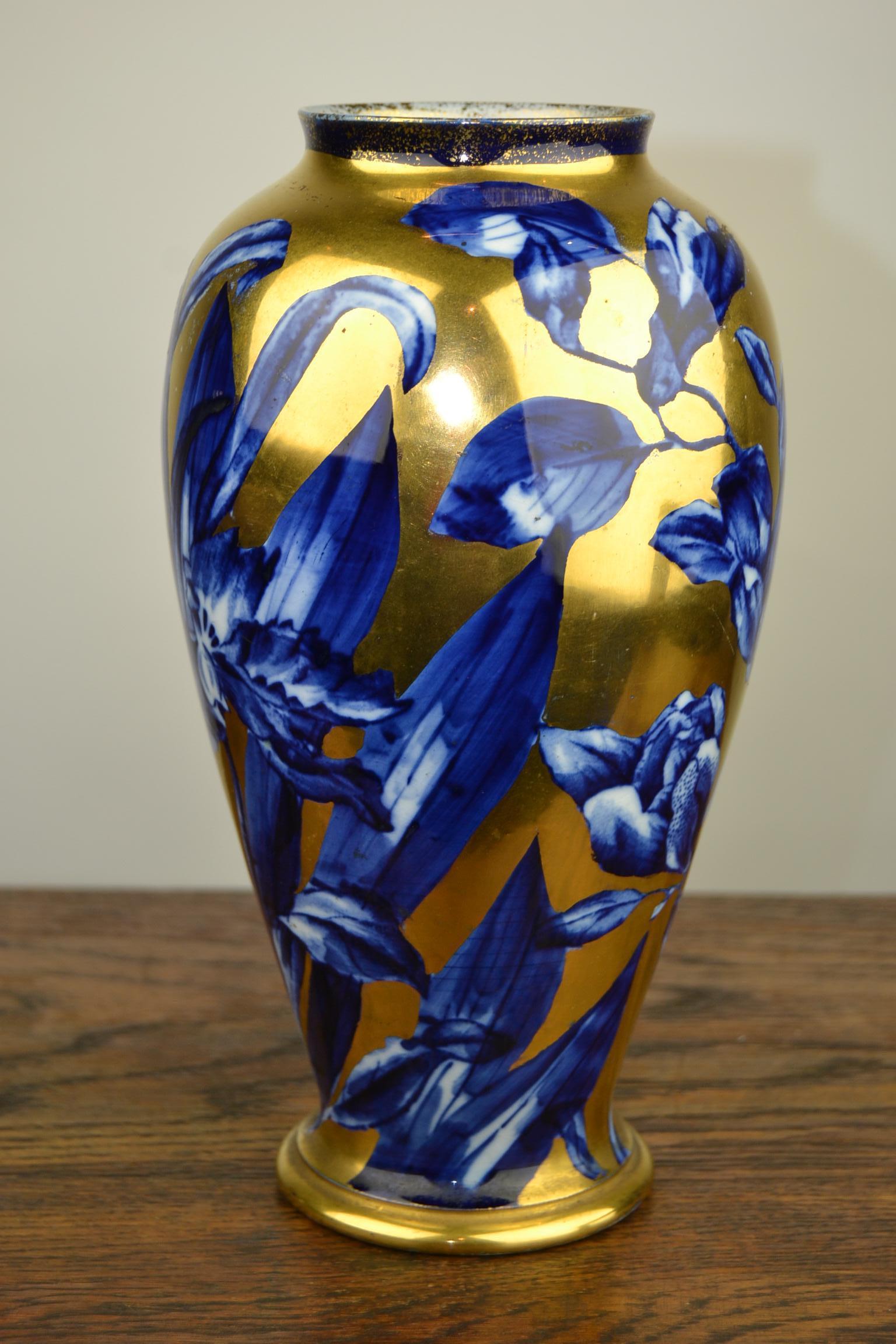 Stylish Art Nouveau Vase by Thomas Forester Pottery England.
Hand-painted Floral Design with great use of the colors Cobalt Blue and Gold.
A short everted lip above a tapering Body ending in a splayed Foot.
This Flow Blue Vase is Stamped on the