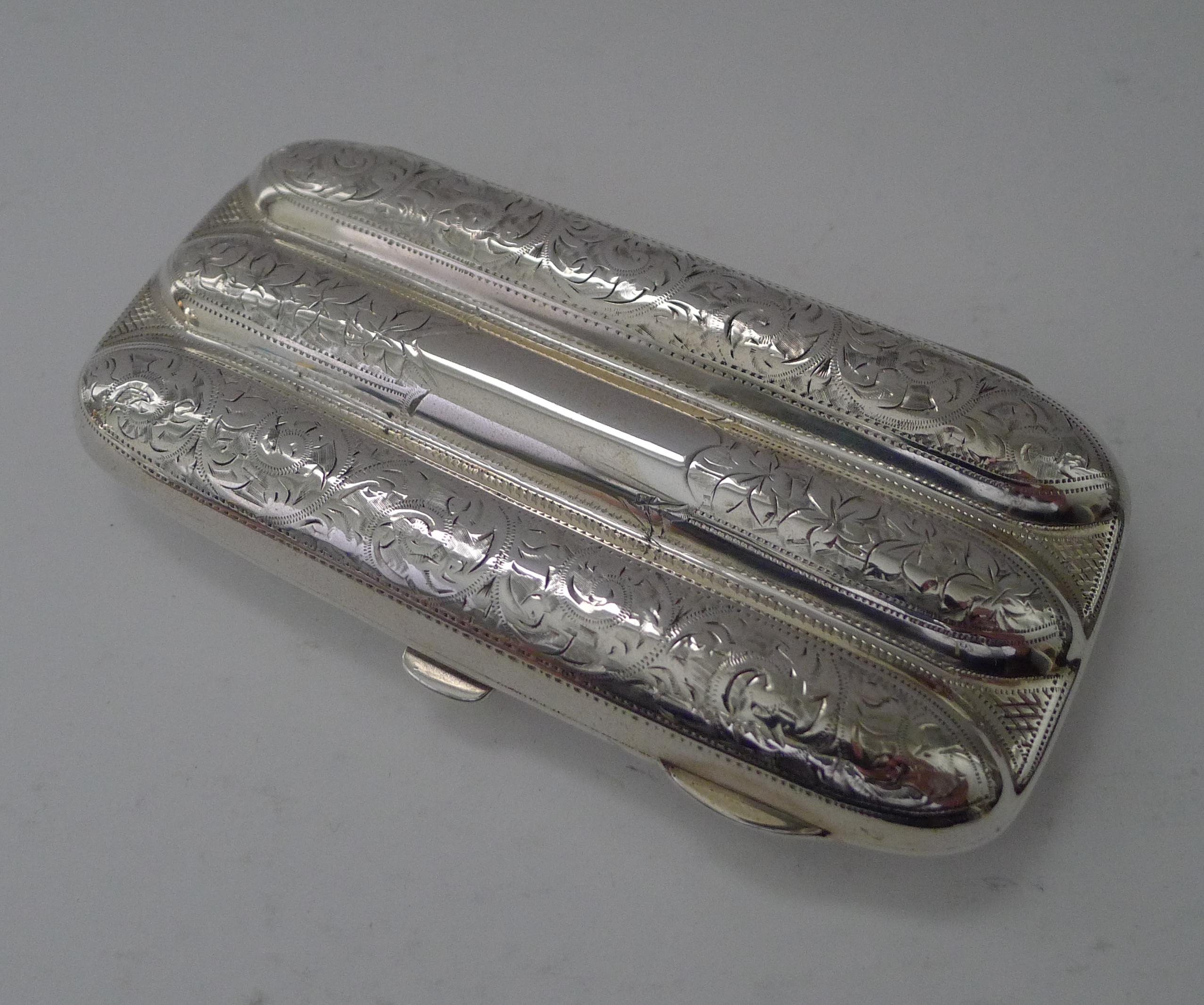A handsome English solid sterling silver cigar case, beautifully engraved with a vacant shield-shaped cartouche to the front.

The hinge and clasp to the front are in perfect working order, the case snaps shut securely.

The interior reveals the