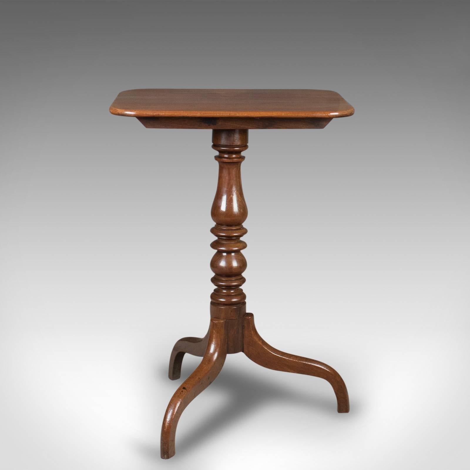 This is an antique, tilt-top wine table in mahogany, English, Georgian and dating to the early 19th century.

Classic tripod form with elegant down-swept legs
Robust quadruple turned baluster stem
Original iron catch with addition, hinged for