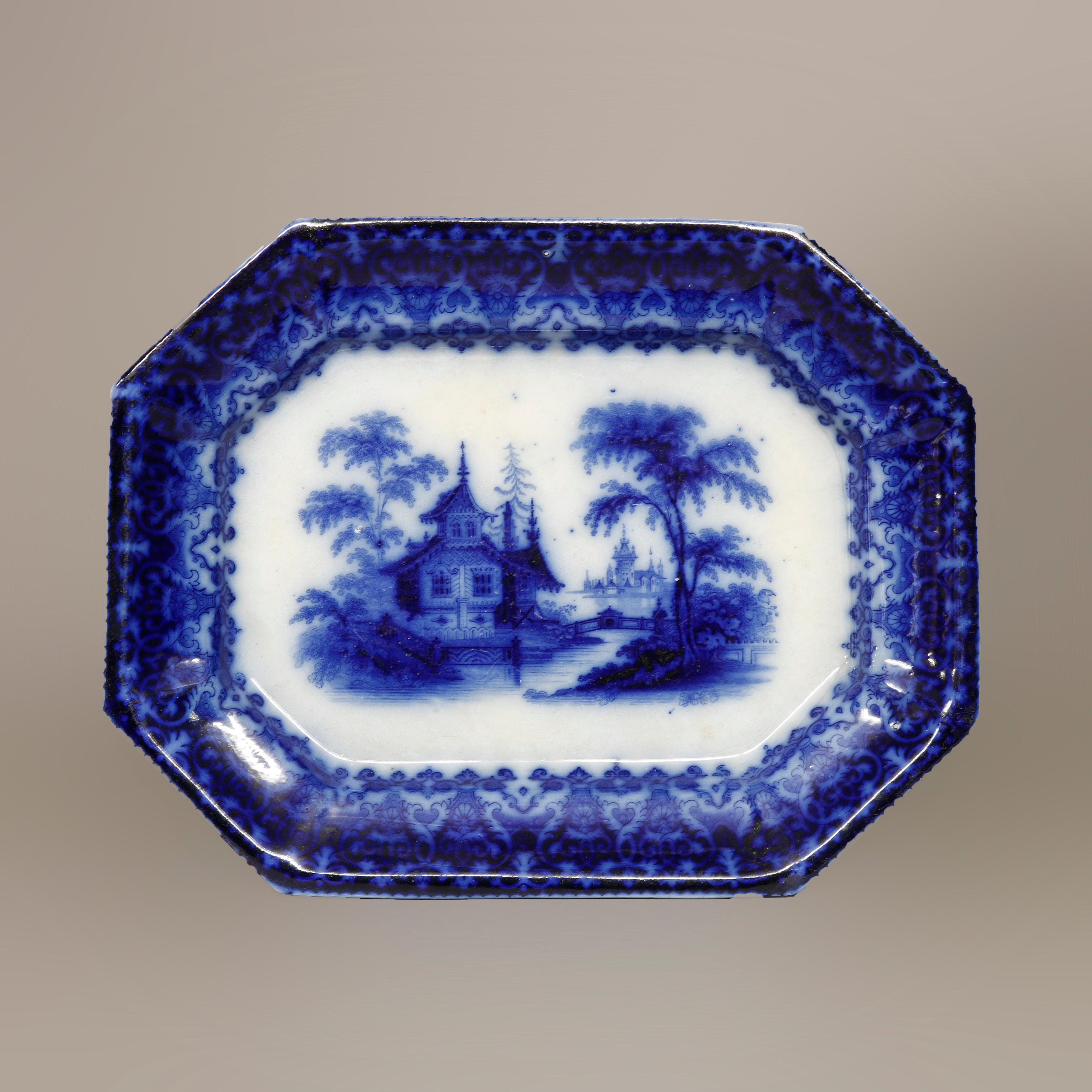 An antique platter by TJ&J Mayer offers porcelain construction with flow blue Chinoiserie decoration including well with landscape scene having structure and Persian pattern on rim, maker mark en verso as photographed, reminiscent of English