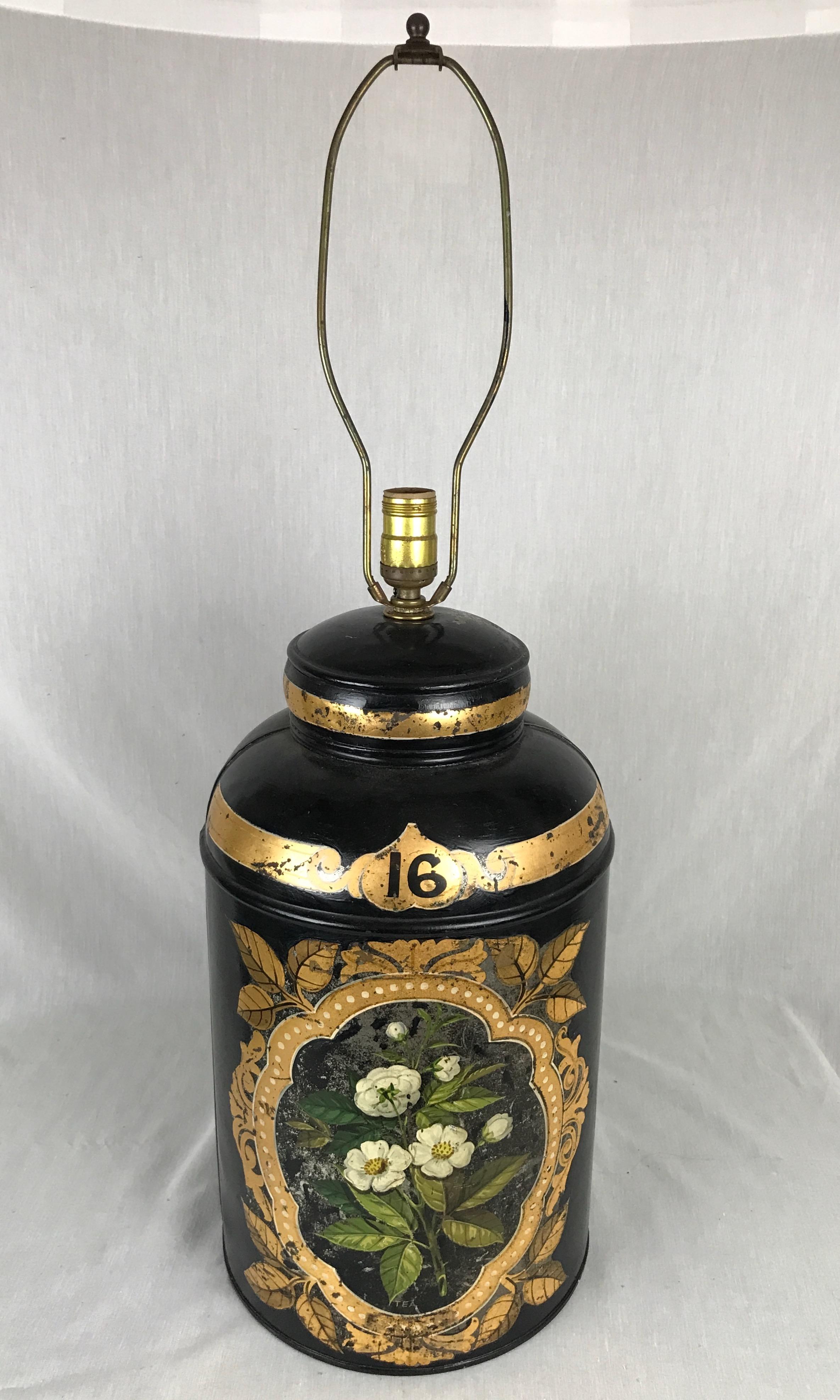 Antique tole painted and gilt tea canister converted to a lamp. Has original label on the back Parnall & Sons, Ltd. 