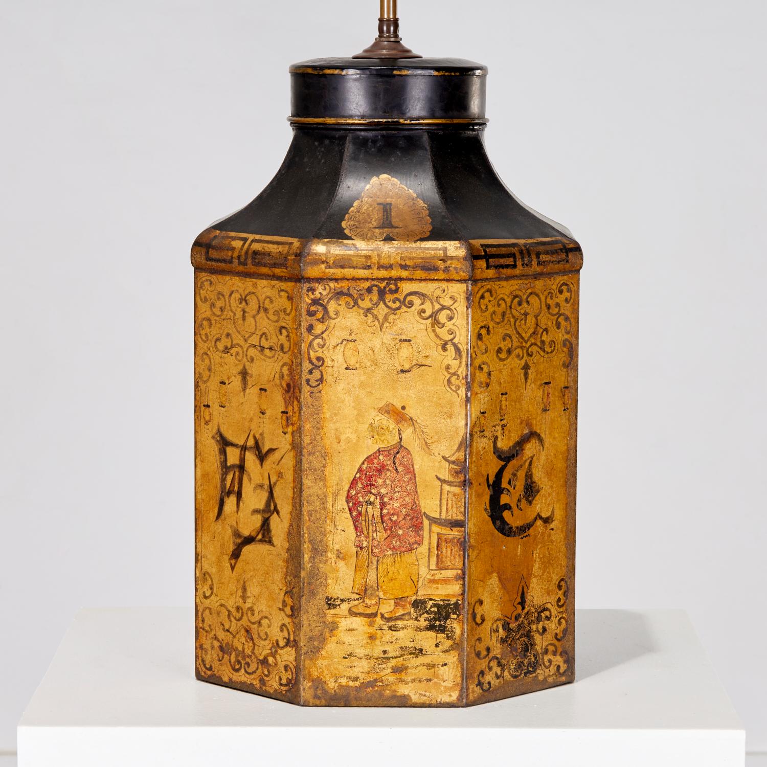 Late 19th c. , black and gold painted English tea canister with Chinoiserie decoration, mounted as 3-light table lamp with tall brass finial.

This lamp has great character and the painting is quite charming. The lovely hanging lanterns suggest a