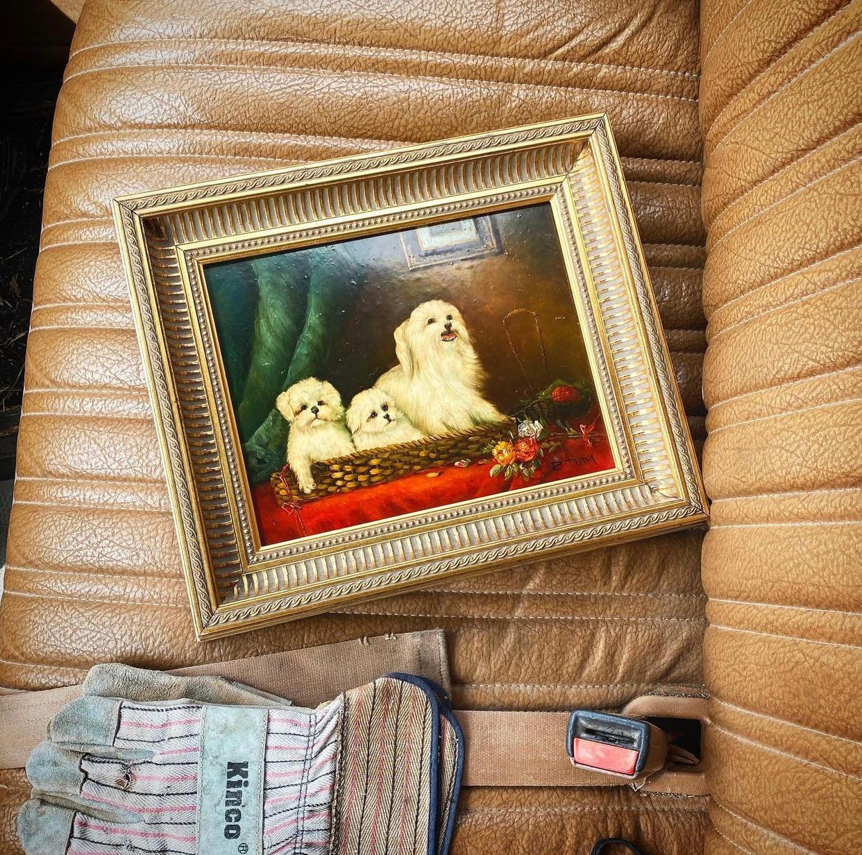 A fine English piece of artwork featuring a Maltese dog and her two small pups. This piece is framed in a giltwood frame and signed by the artist at the bottom right. The piece is on wood and highly lacquered. 

The subject of this still life is a