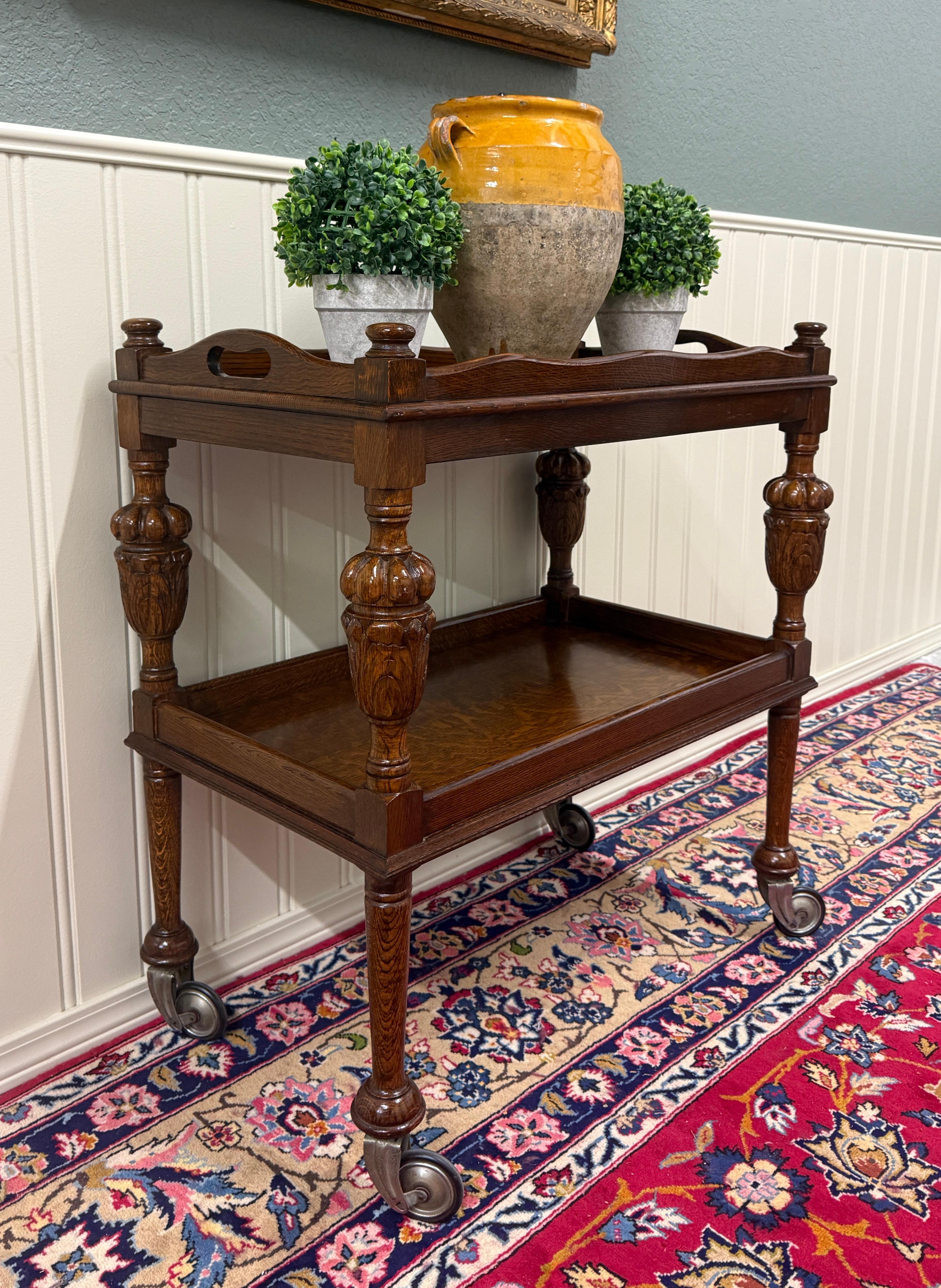 CHARMING Antique English Oak Two-Tier Tea/Pastry Cart, Trolley or End Table Side Occasional Table~~Lift Out Serving Tray~~c. 1930s

Excellent Tudor style with cup & cover legs~~large original casters with dual spring absorbers
 
Versatile
