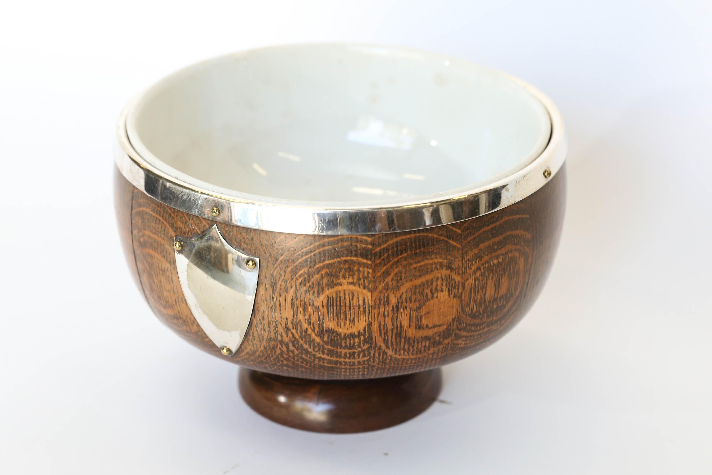 Antique English pedestal trophy bowl made from the traditional English oak with silver plate rim and trophy shield. The removable ironstone interior bowl measures 8.5 inches in diameter and stands 3.75 high. Measurements below are for the total