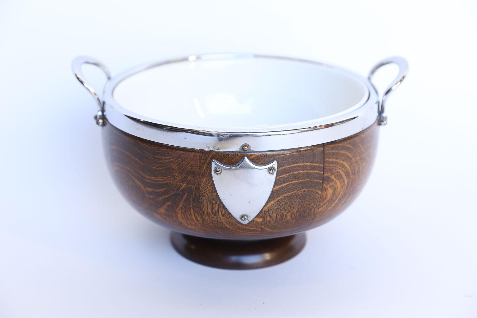 Antique English pedestal bowl made from the traditional English oak with silver plate rim, handles and trophy shield. The removable ironstone interior bowl measures 8.5