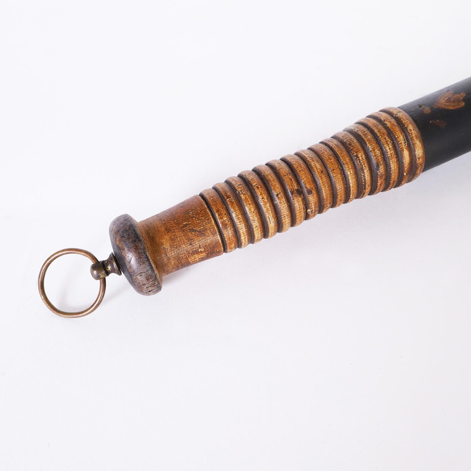 Rare and unusual antique billy club or truncheon bedecked with a polychrome technique, the coat of arms and motto ( Honi Soit Qui Mal Y) of the Order of the Garter, an order of Knighthood founded in 1348 by King Edward III.
