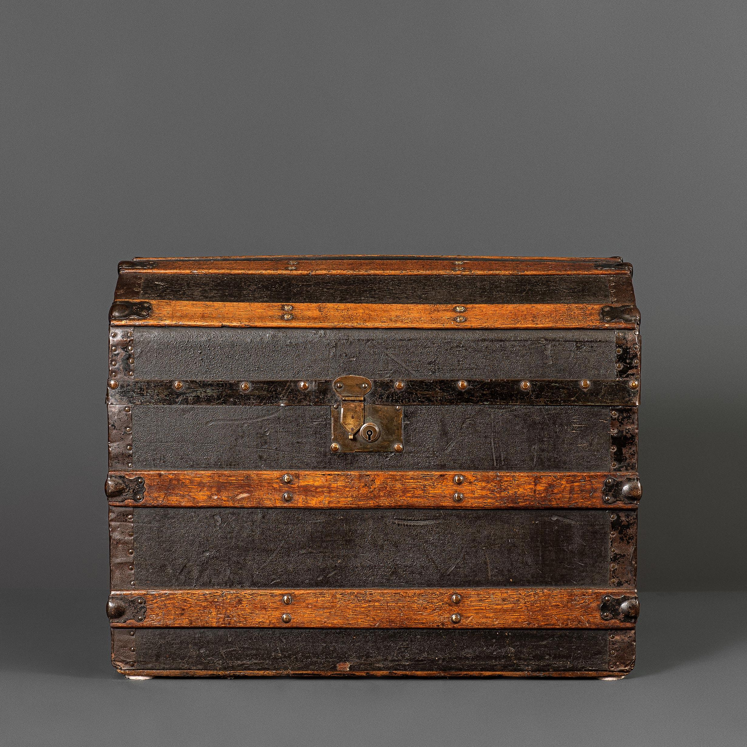 A dome topped English trunk made from oak and pine with brass fittings. Wonderful colouring. Decorative and practical storage piece.